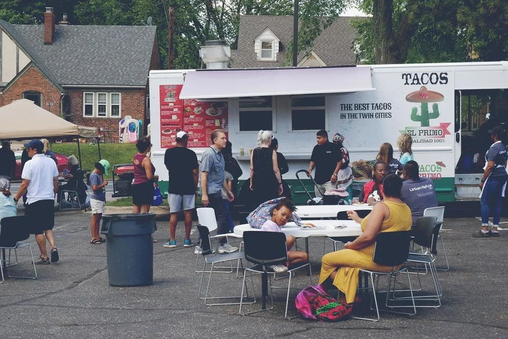people attending the Hope & Help Resource Fair with food truck in background