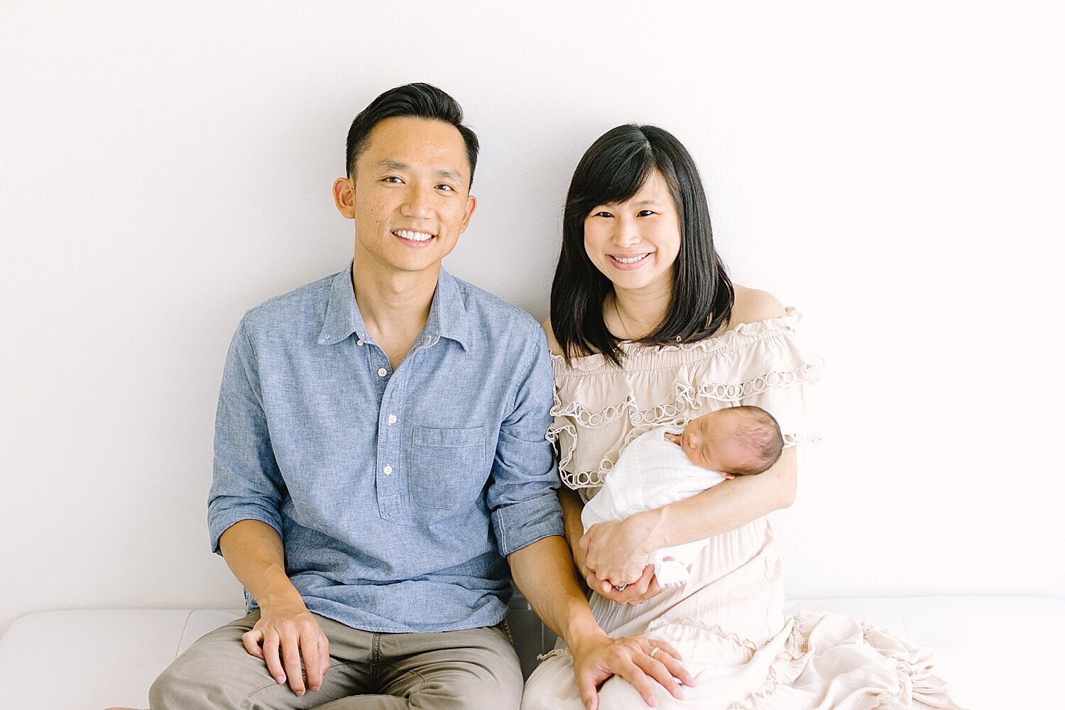 Mom and Dad with their newborn son in Newport Beach Photography Studio. Photos by Ambre Williams Photography.