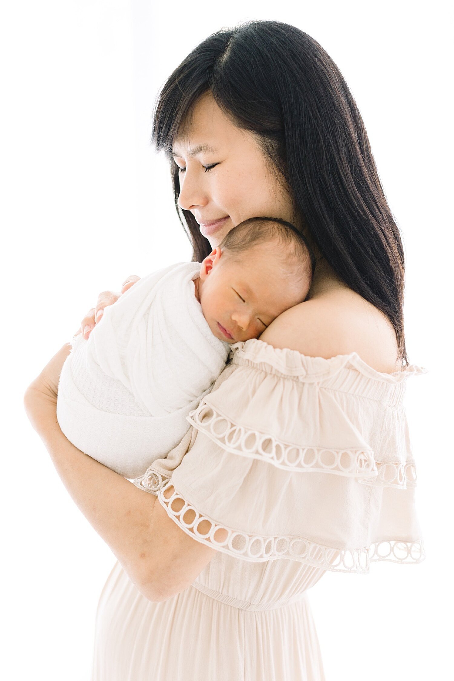 Mom holding her fourth baby, a boy! Photo by Newport Beach newborn photographer, Ambre Williams Photography.