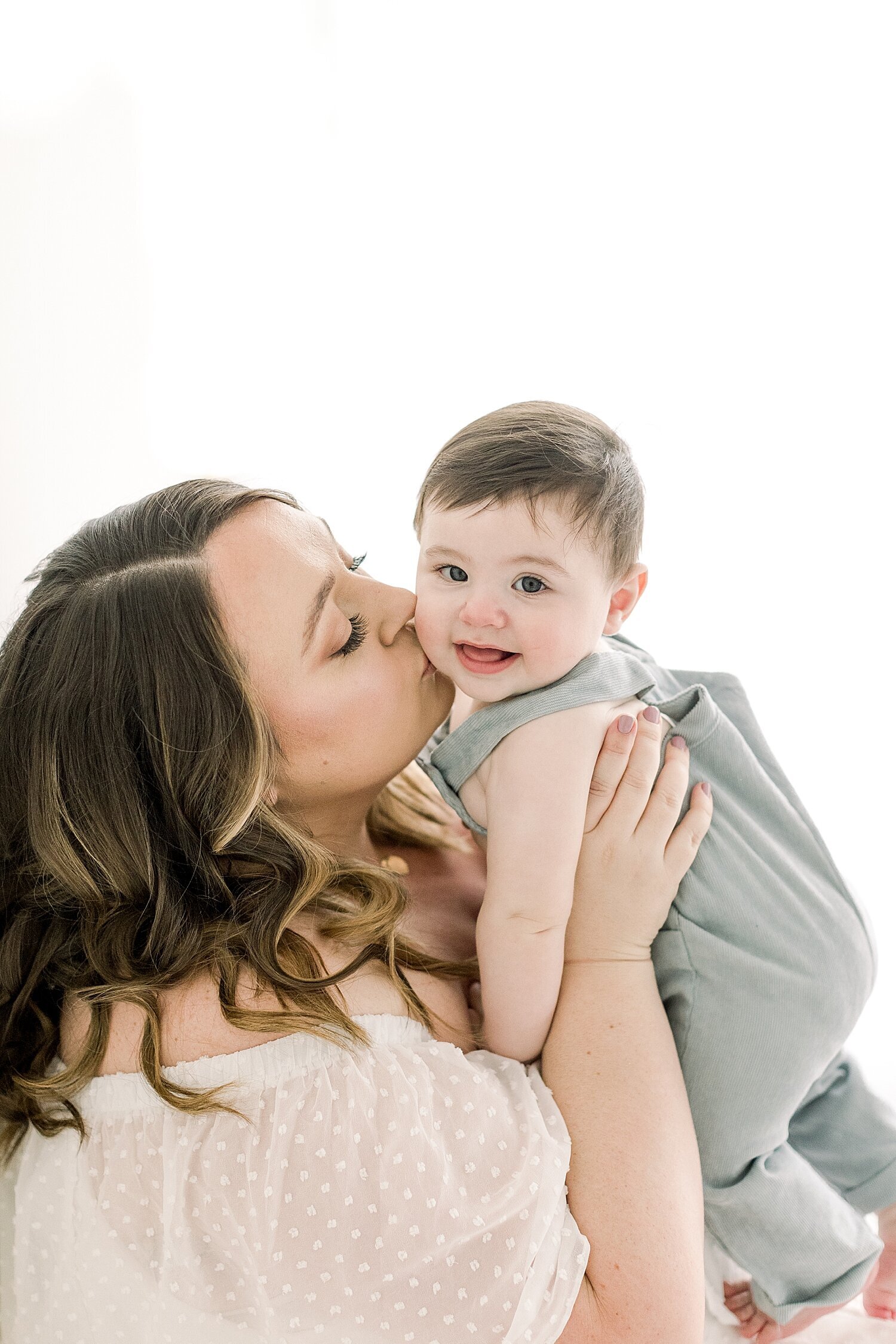 Mom kissing her baby boy during photoshoot with Ambre Williams Photography.
