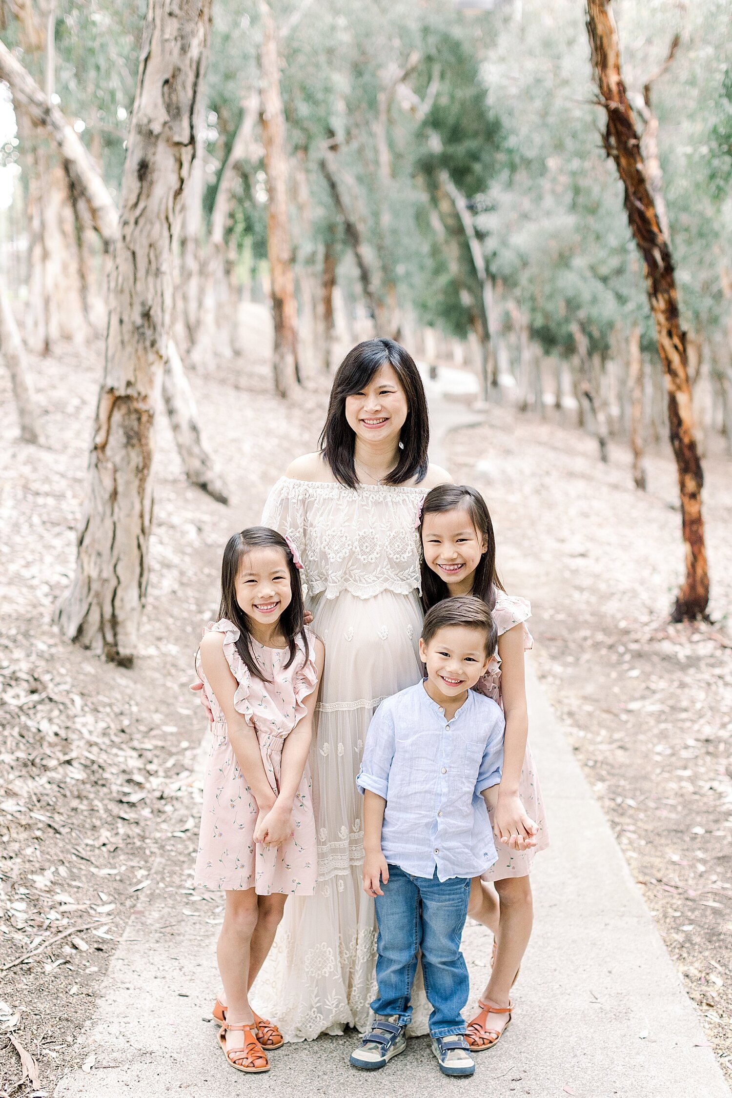 Pregnant mom with her 3 children. Photo by Ambre Williams Photography.