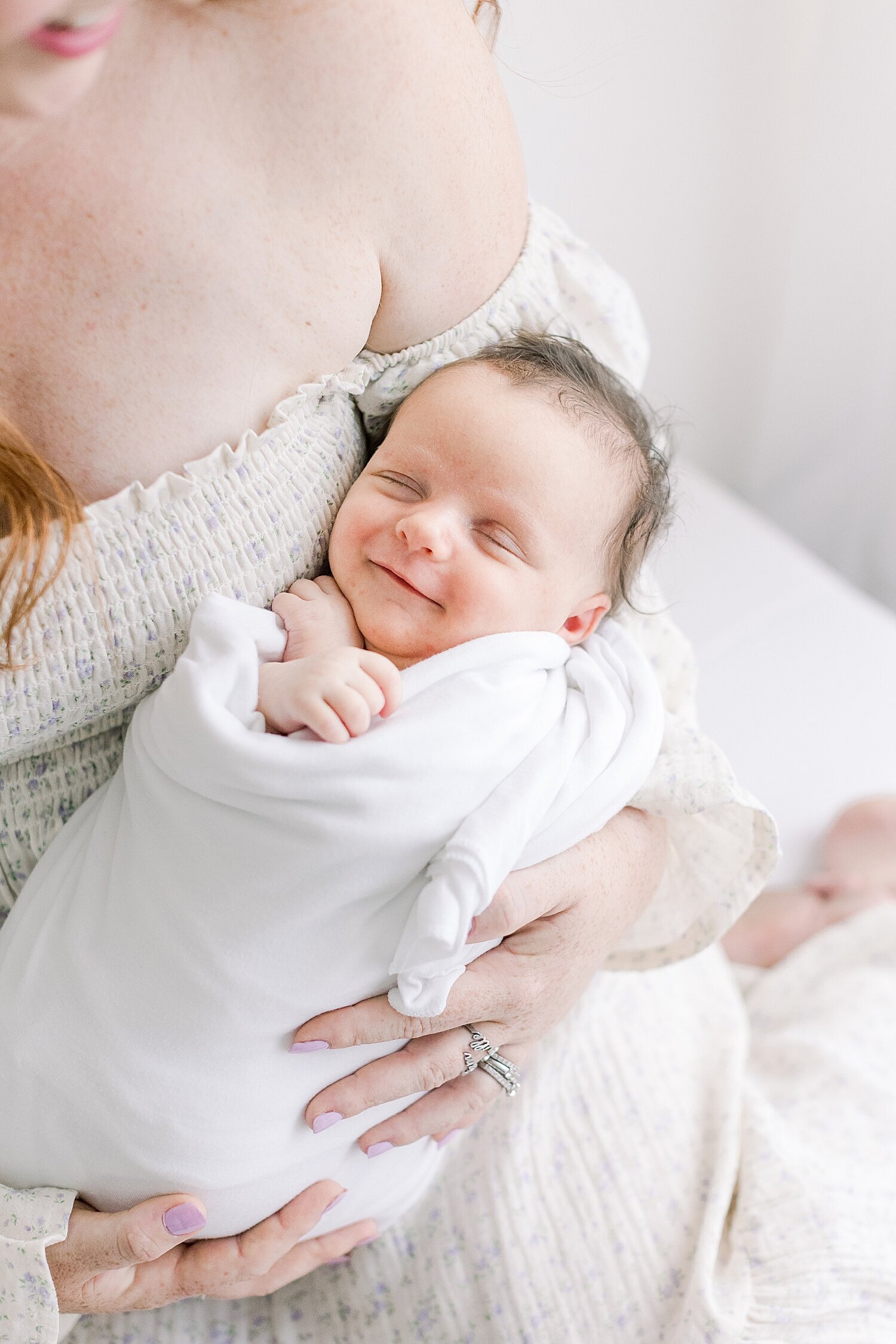 Baby girl smiling during newborn session. Photo by Ambre Williams Photography.