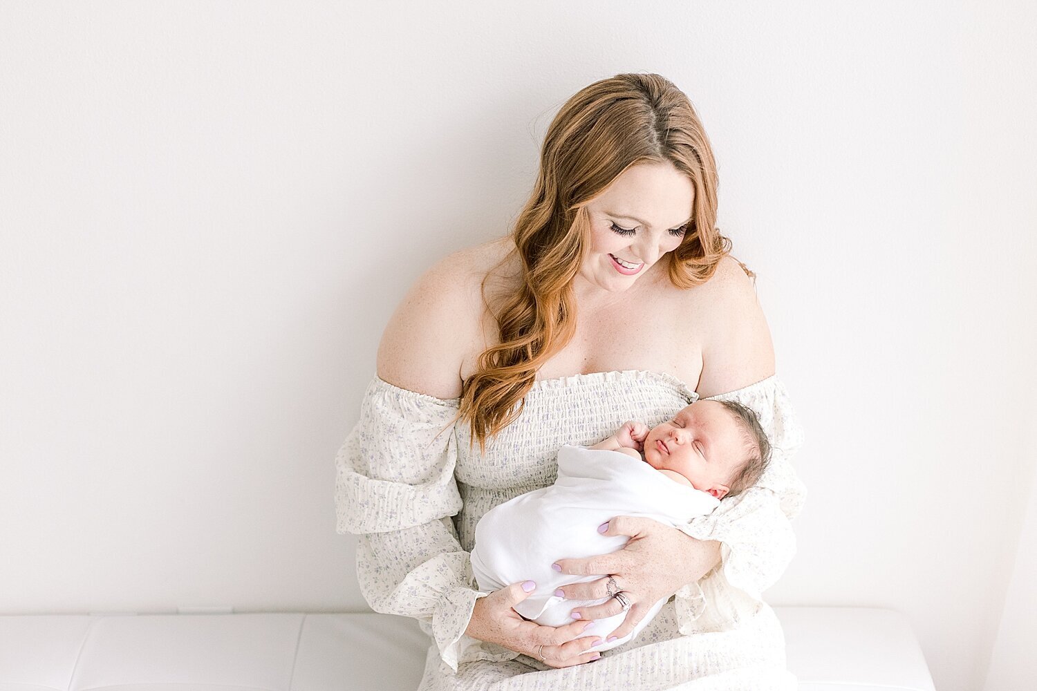 Mom holding her baby girl. Photo by Ambre Williams Photography.