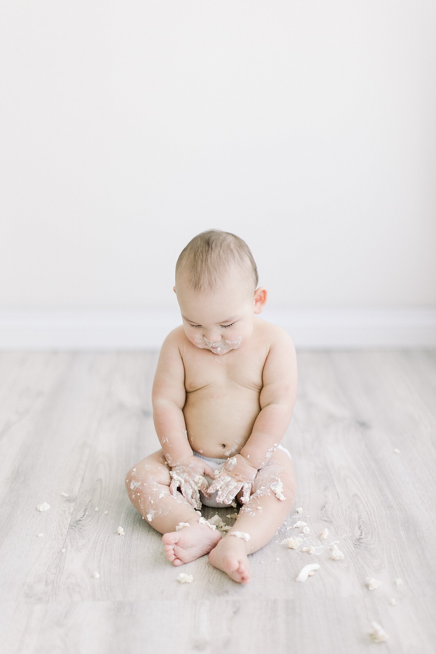Aftermath of a one year cake smash birthday session. Photo by Ambre Williams Photography.