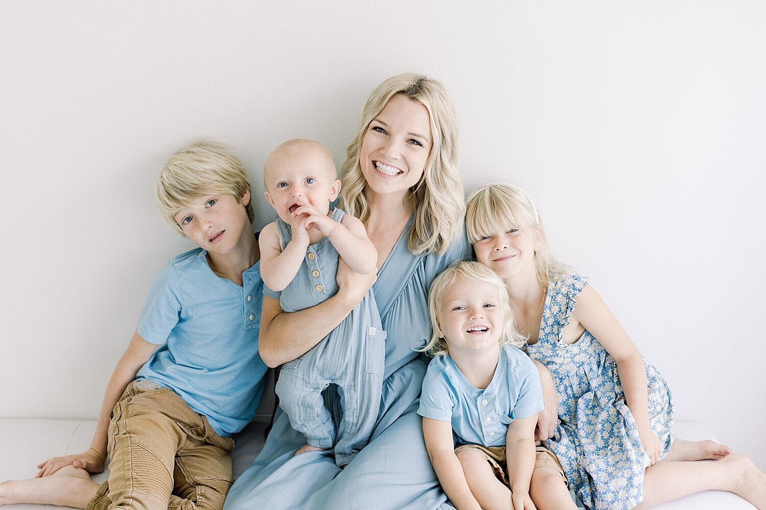 Mama snuggling her babies during motherhood celebration event with Ambre Williams Photography in Newport Beach, CA.