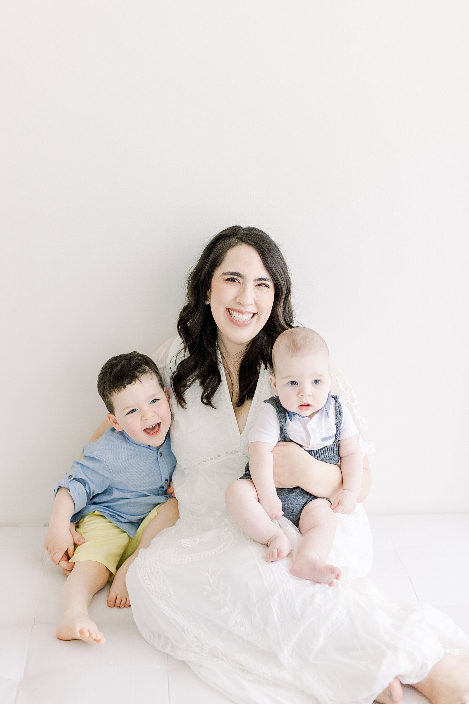 Mom and her two boys smiling for photos with Ambre Williams Photography.