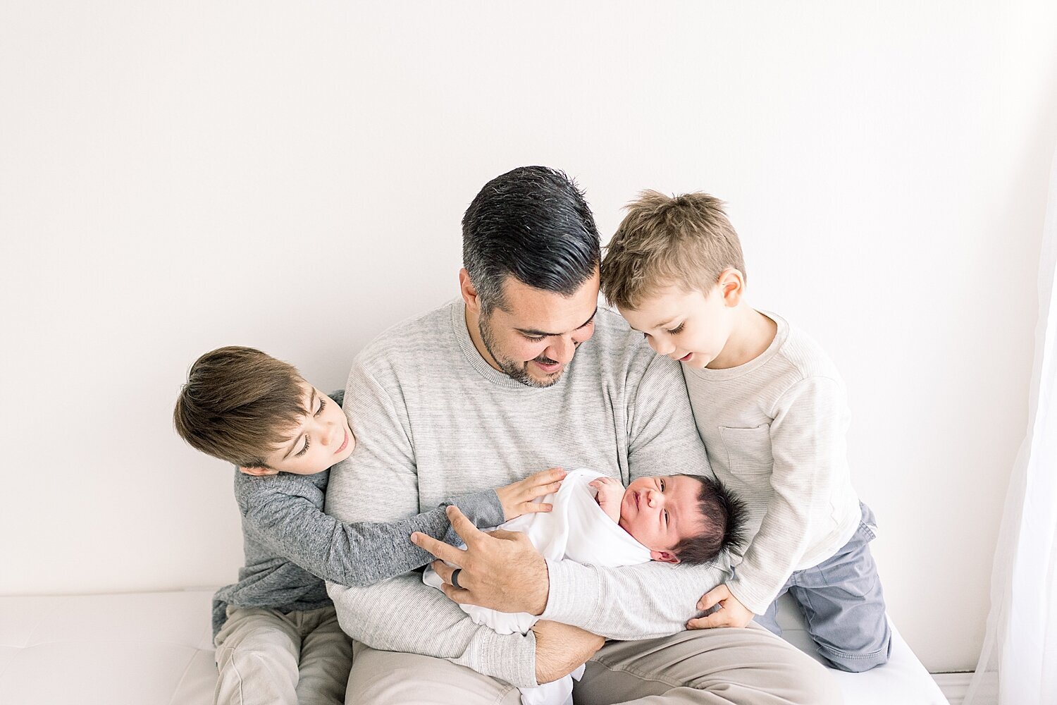 Dad and his three boys. Photo by Ambre Williams Photography.