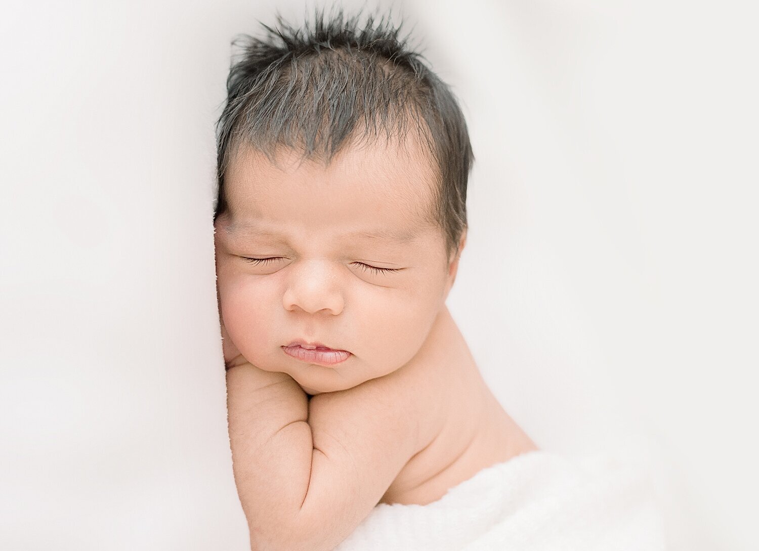 Baby boy laying on his stomach for newborn session in Newport Beach with Ambre Williams Photography.