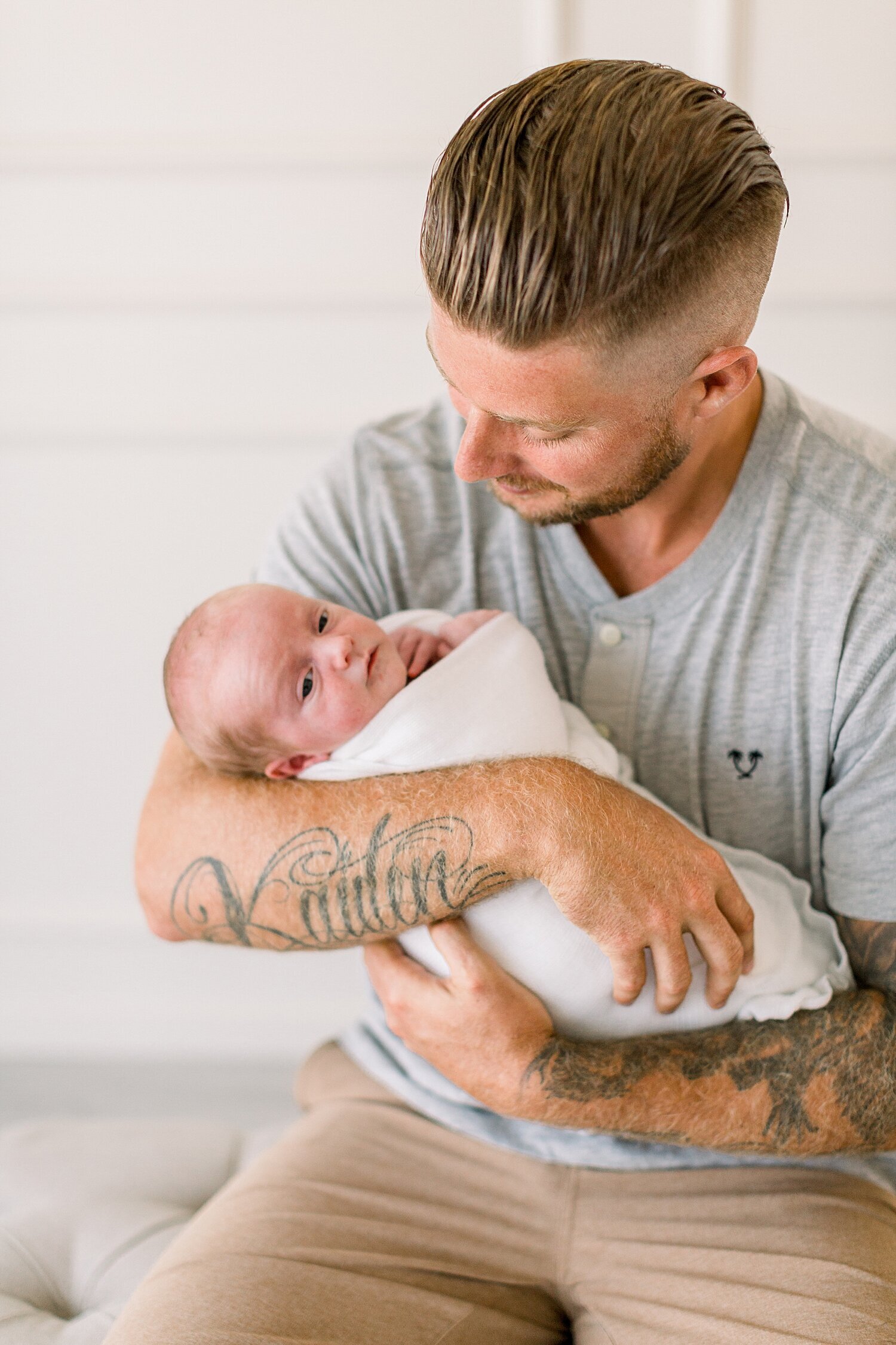Father holding his baby boy for photos with Ambre Williams Photography.