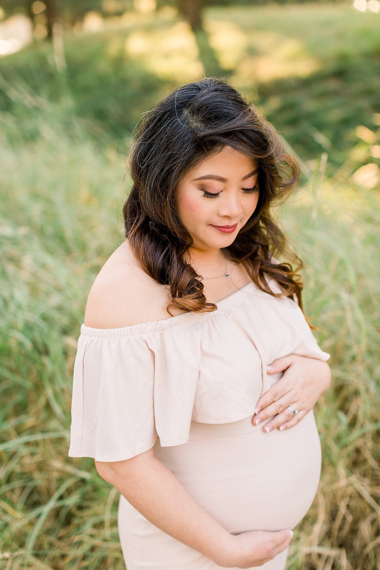 Mama looking at her baby belly during maternity session with Ambre Williams Photography.