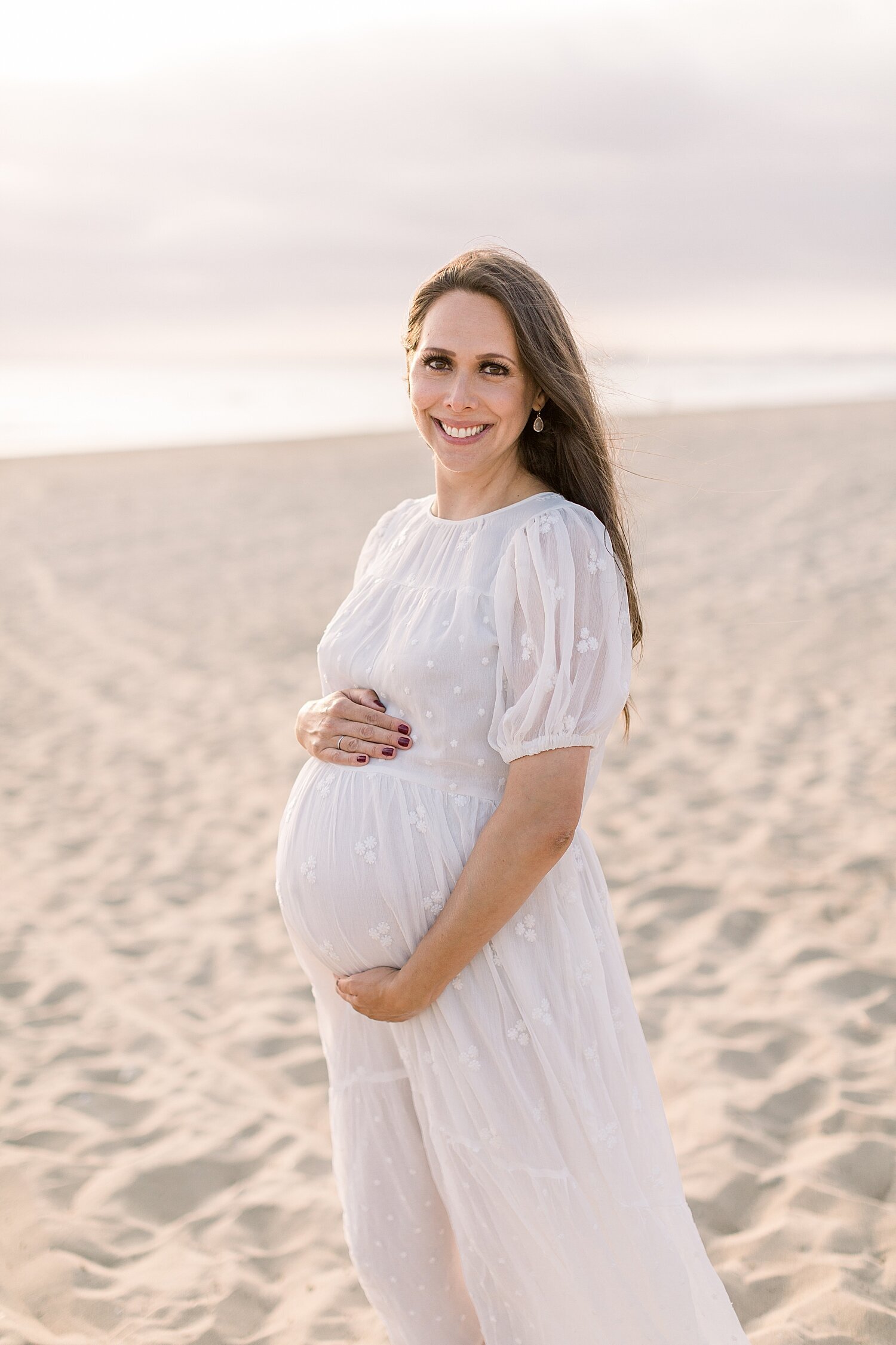 Stunning pregnant mama on the beach for maternity session. Photos by Ambre Williams Photography. 