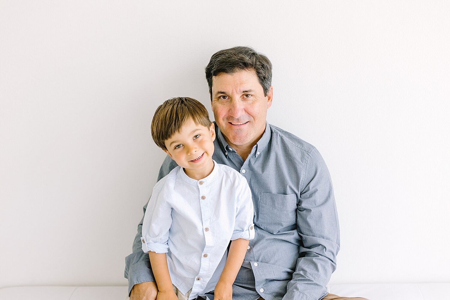 Father-son photo in studio with Ambre Williams Photography in Newport Beach.