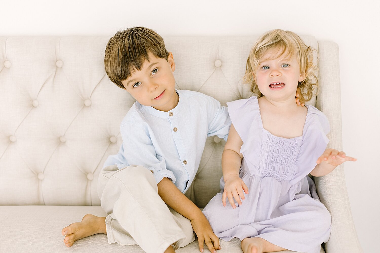 Brother and sister sitting on couch | Ambre Williams Photography