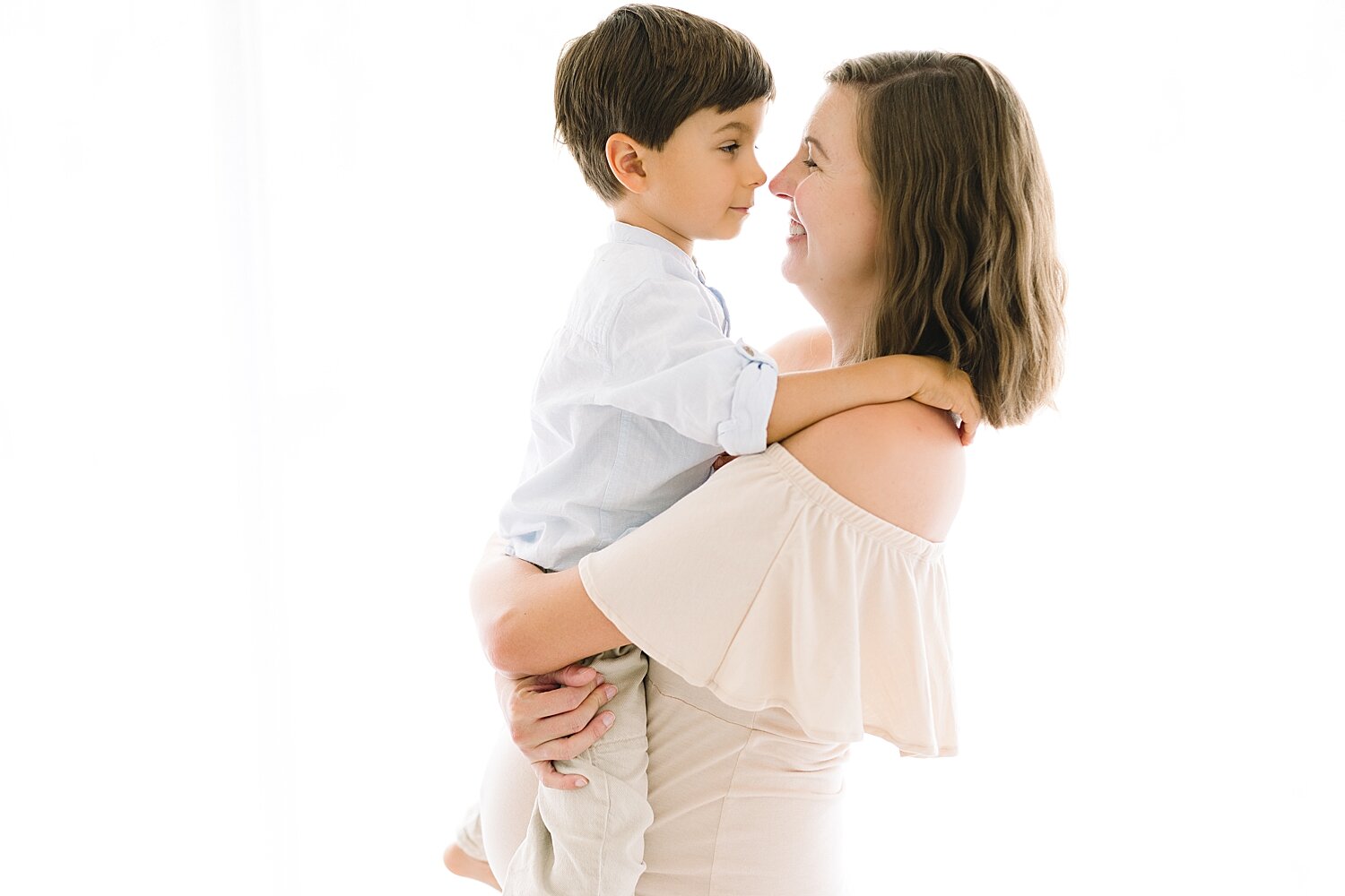 Mom holding her son during maternity photoshoot with baby #3 | Ambre Williams Photography