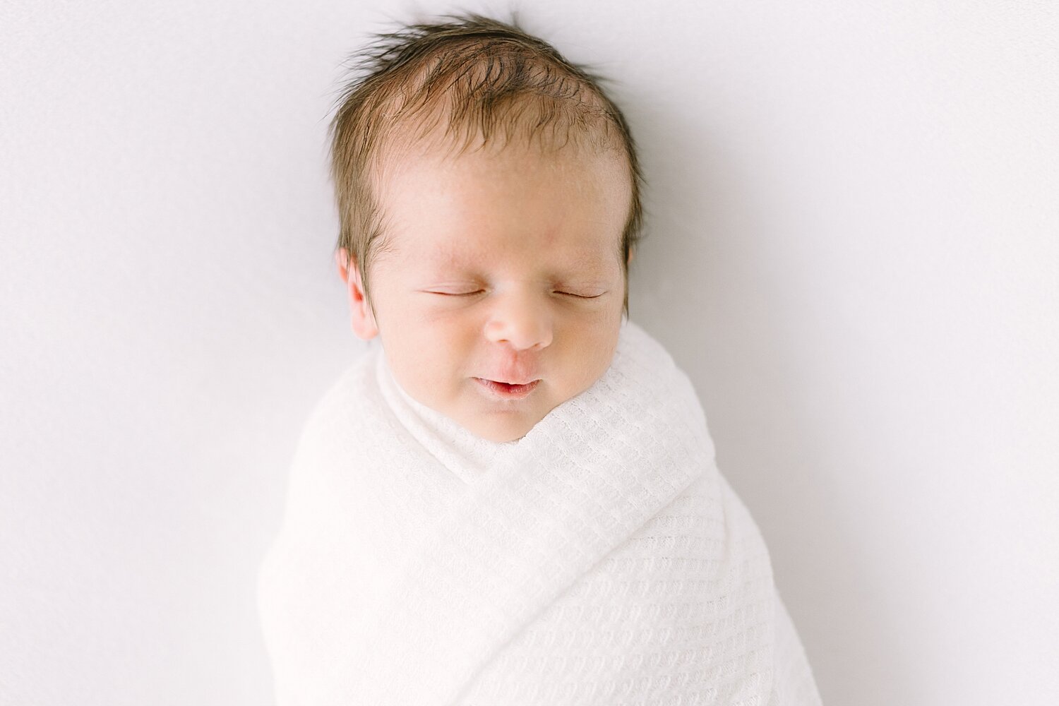 Baby boy swaddled for newborn photos | Ambre Williams Photography