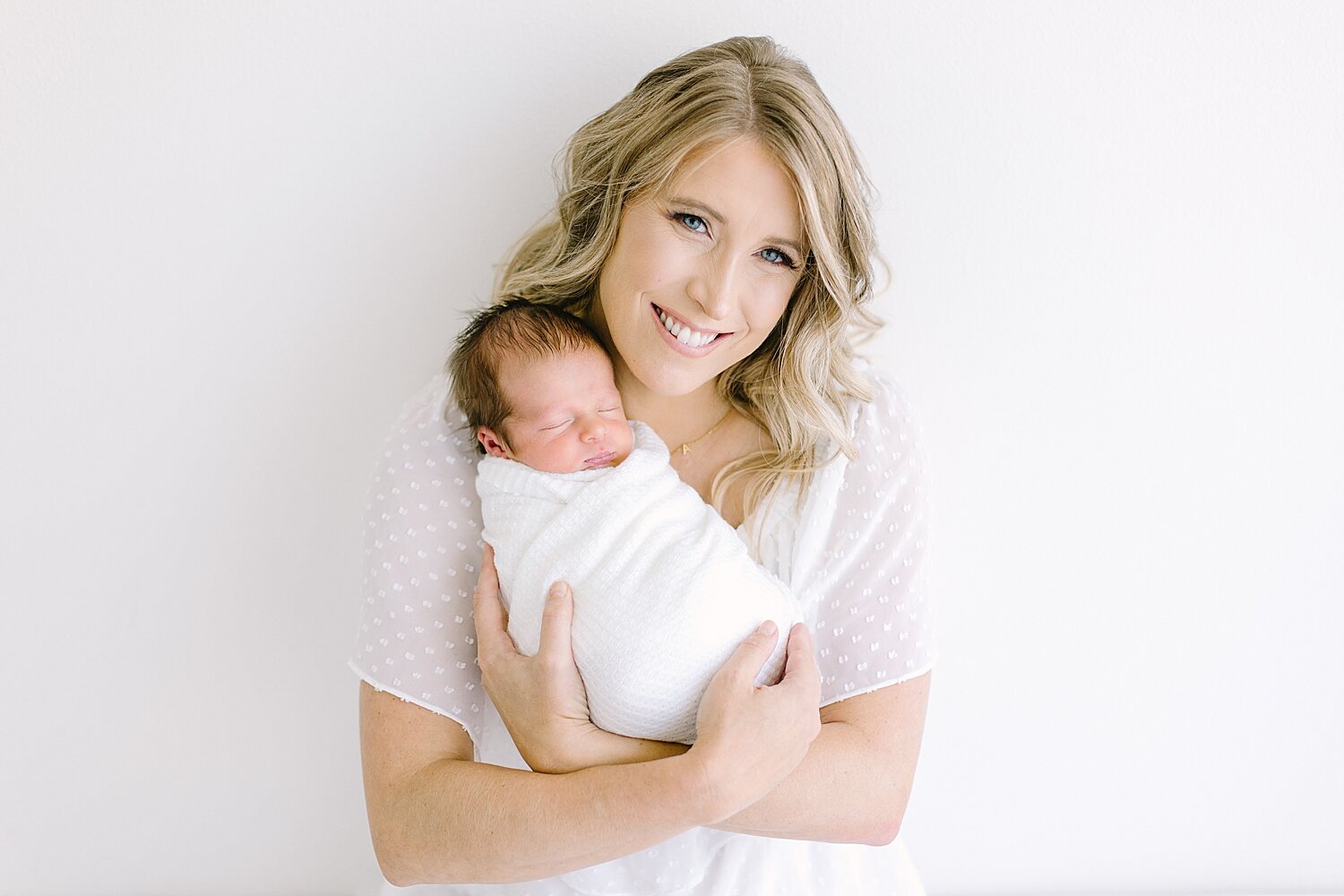 Mom snuggling baby boy during newborn photoshoot with Ambre Williams Photography in Newport Beach, CA.