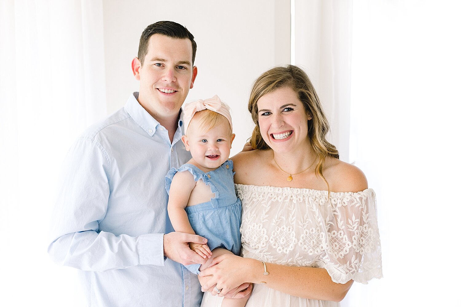Family portrait in studio for baby's first birthday. Photo by Ambre Williams Photography.
