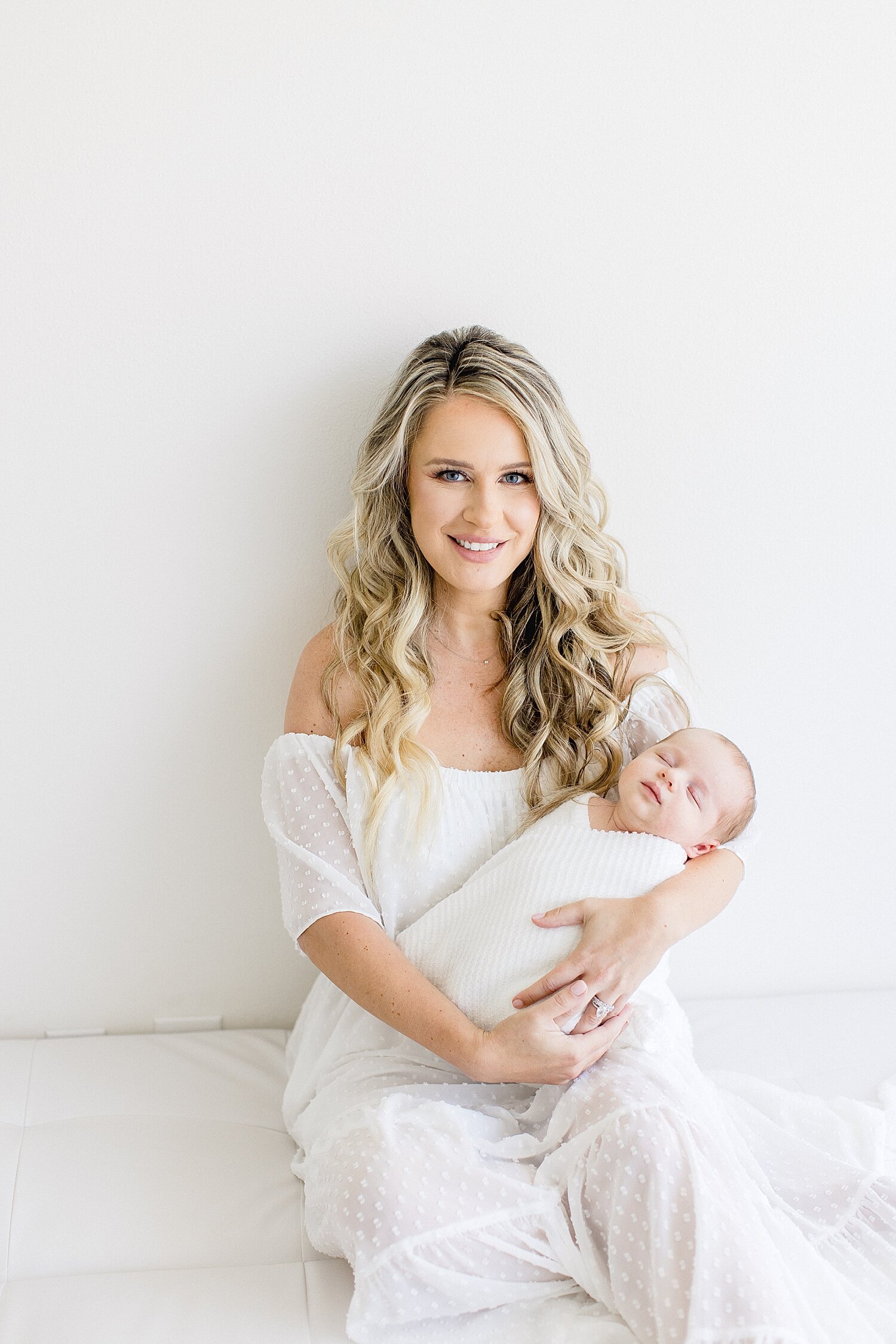 Mom with baby boy during newborn session in Newport Beach studio. Photo by Ambre Williams Photography.