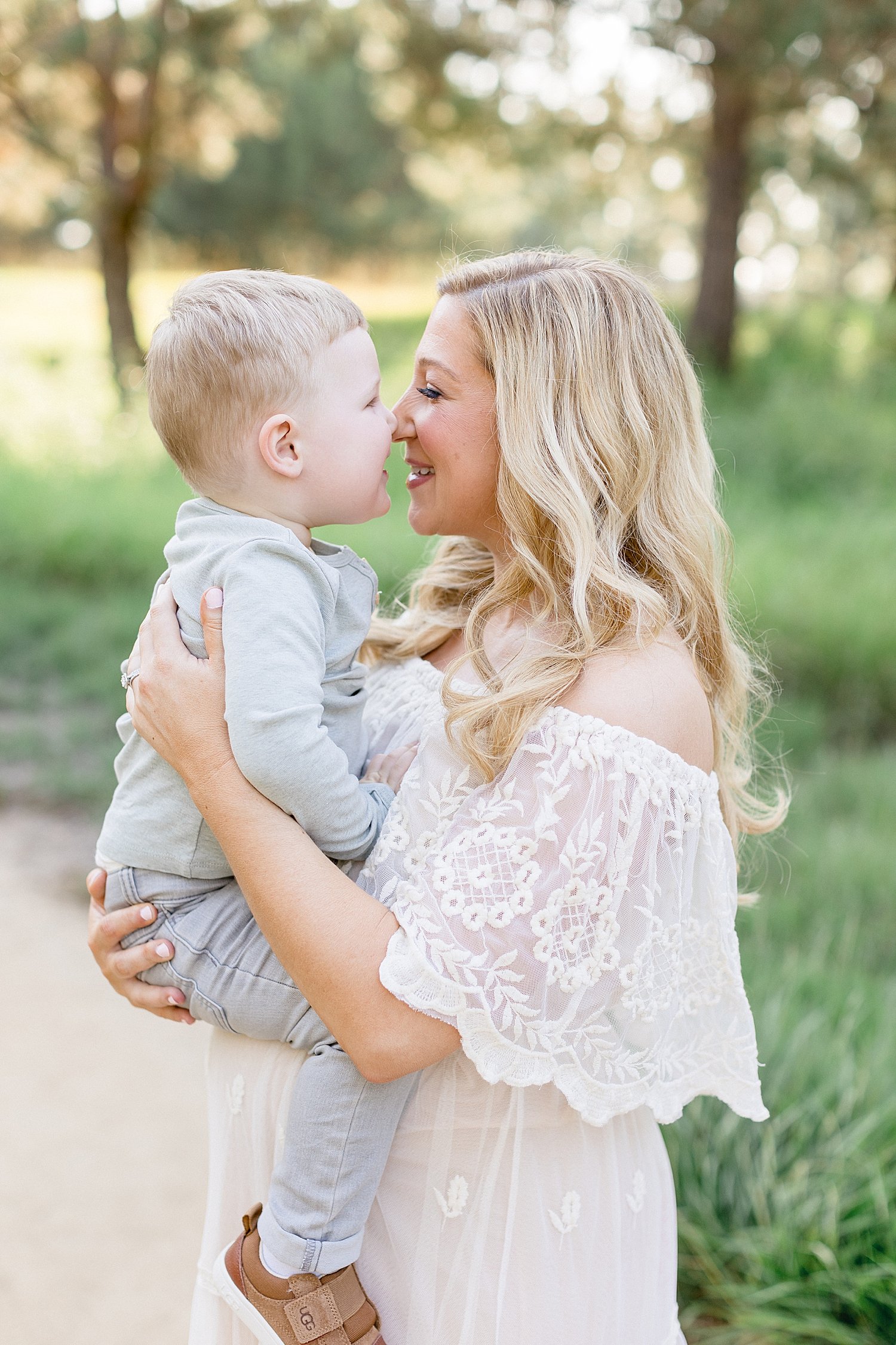 Mom and son nose to nose for sweet moment during maternity photoshoot with Ambre Williams Photography.