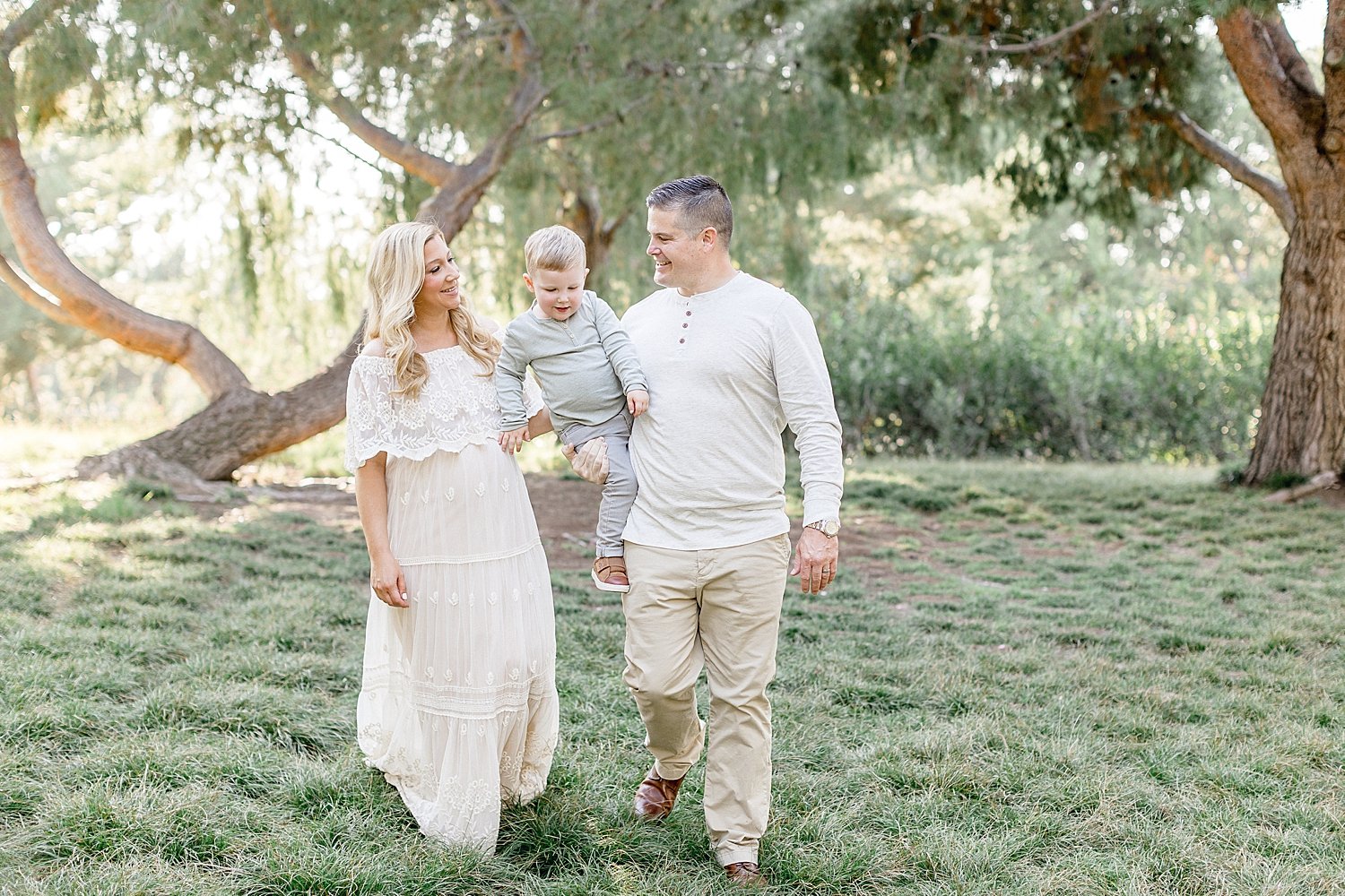 Family walking together during maternity session in Irvine with Ambre Williams Photography.