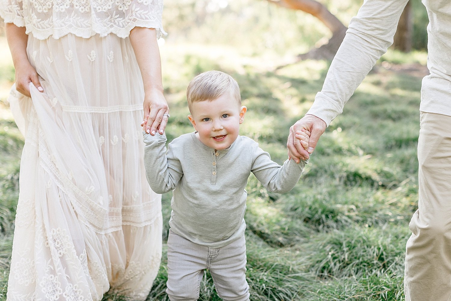 Family walking together during maternity session in Irvine with Ambre Williams Photography.