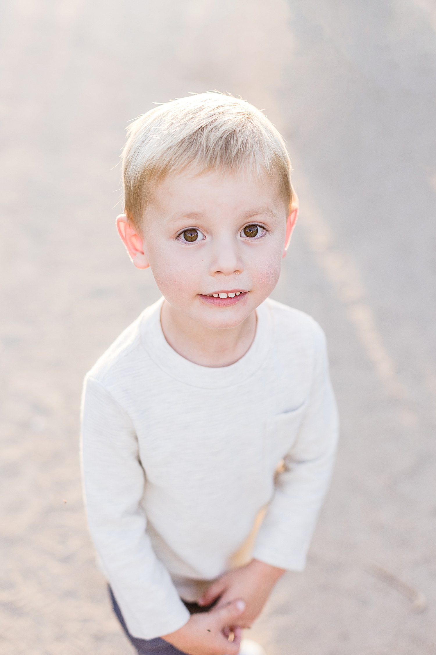 Toddler-aged boy standing and smiling | Ambre Williams Photography