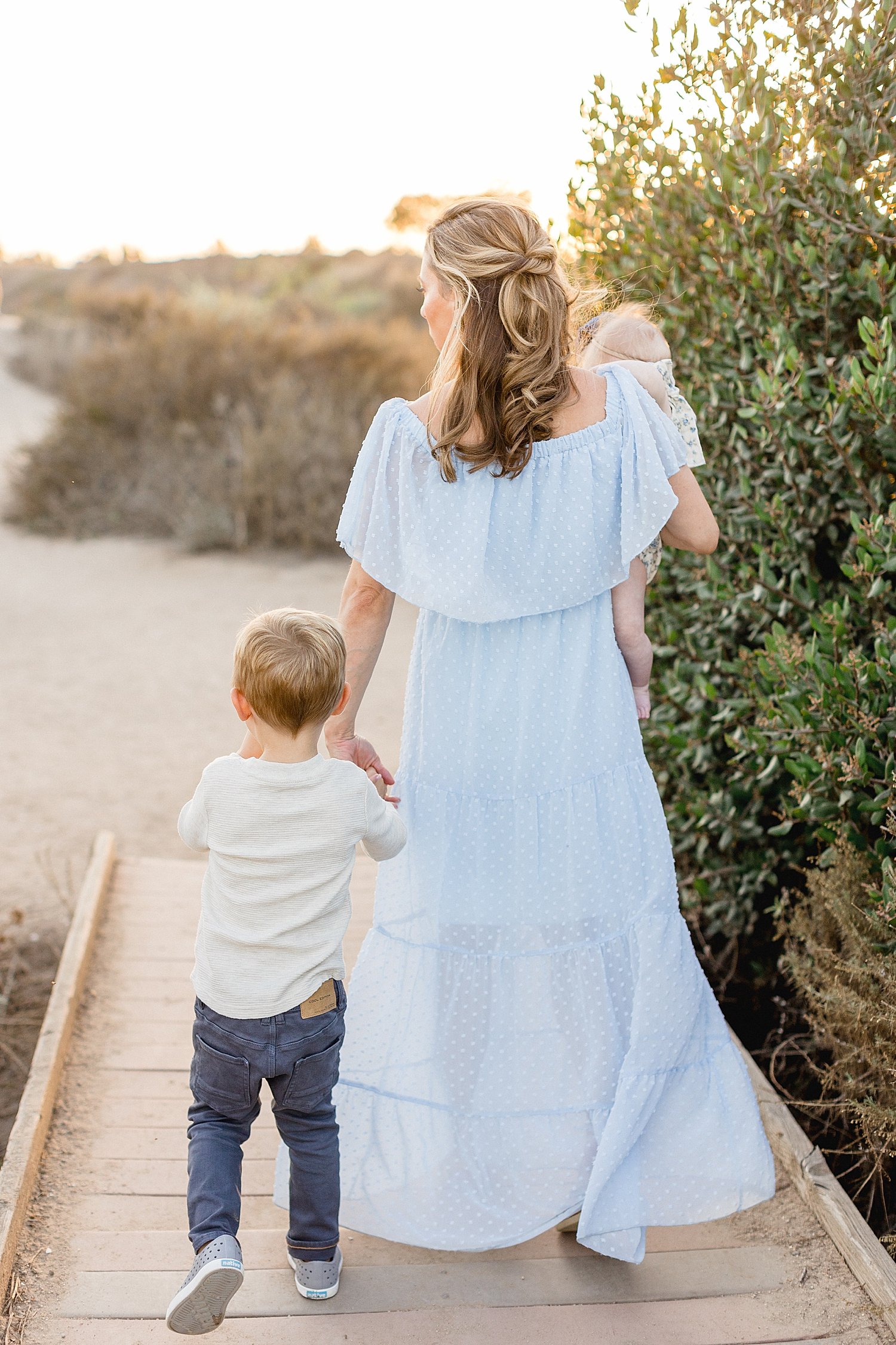 Mom walking into sunset with son and daughter | Ambre Williams Photography