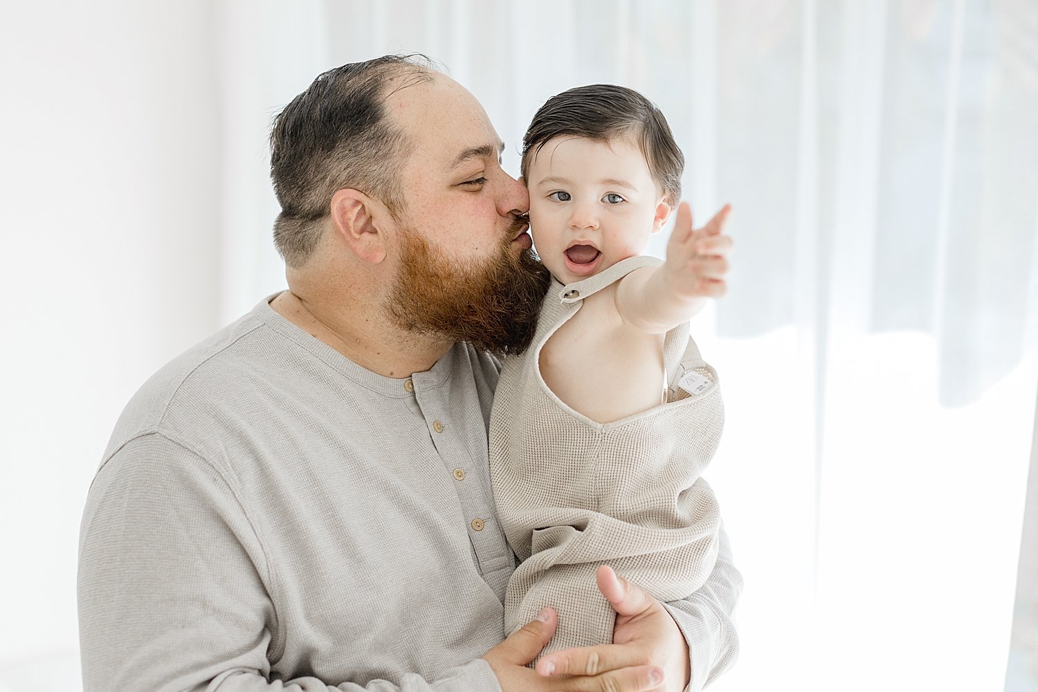 Dad kissing son on cheek | Ambre Williams Photography