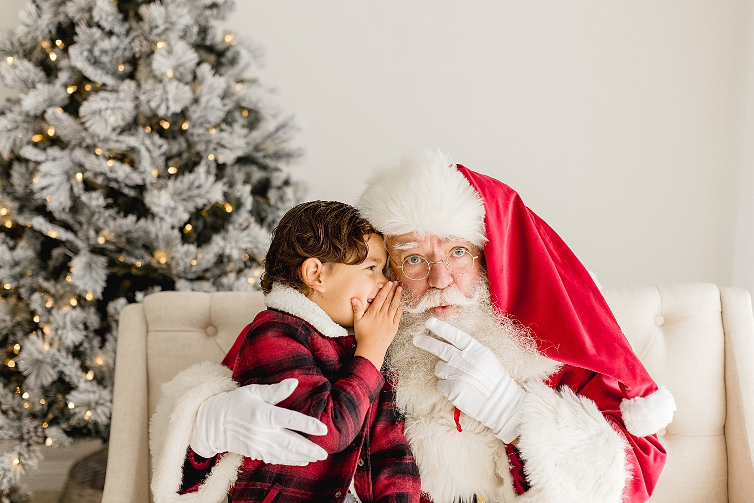 Child telling Santa his wishes | Ambre Williams Photography