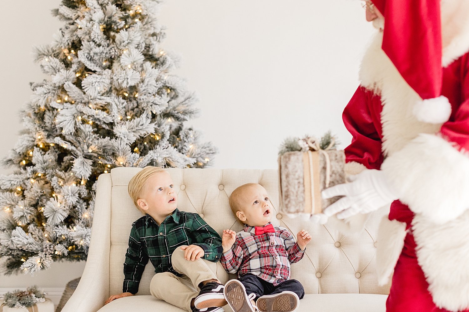 Santa giving kids a gift | Ambre Williams Photography.