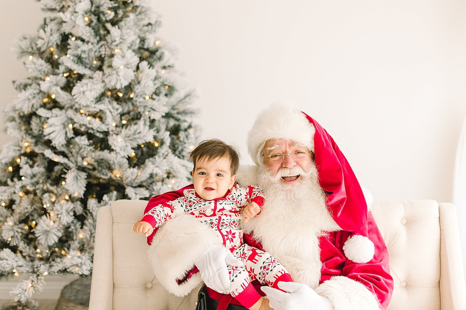 Toddler sitting on Santa's lap at event in Orange County with Ambre Williams Photography.