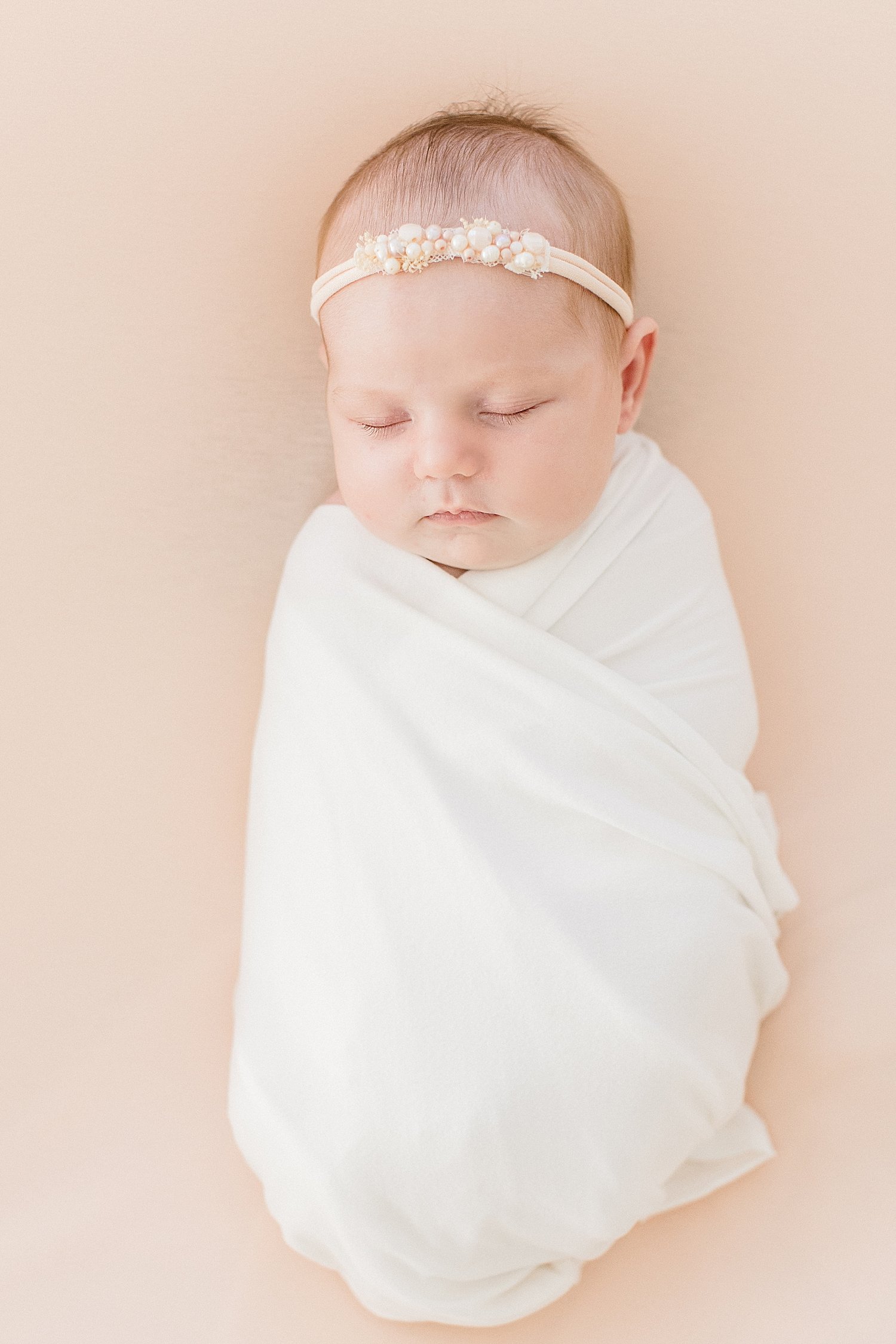 Baby girl swaddled and sleeping for newborn session | Ambre Williams Photography