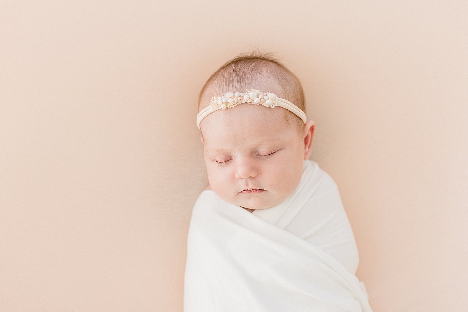 Baby girl swaddled and sleeping for newborn session | Ambre Williams Photography