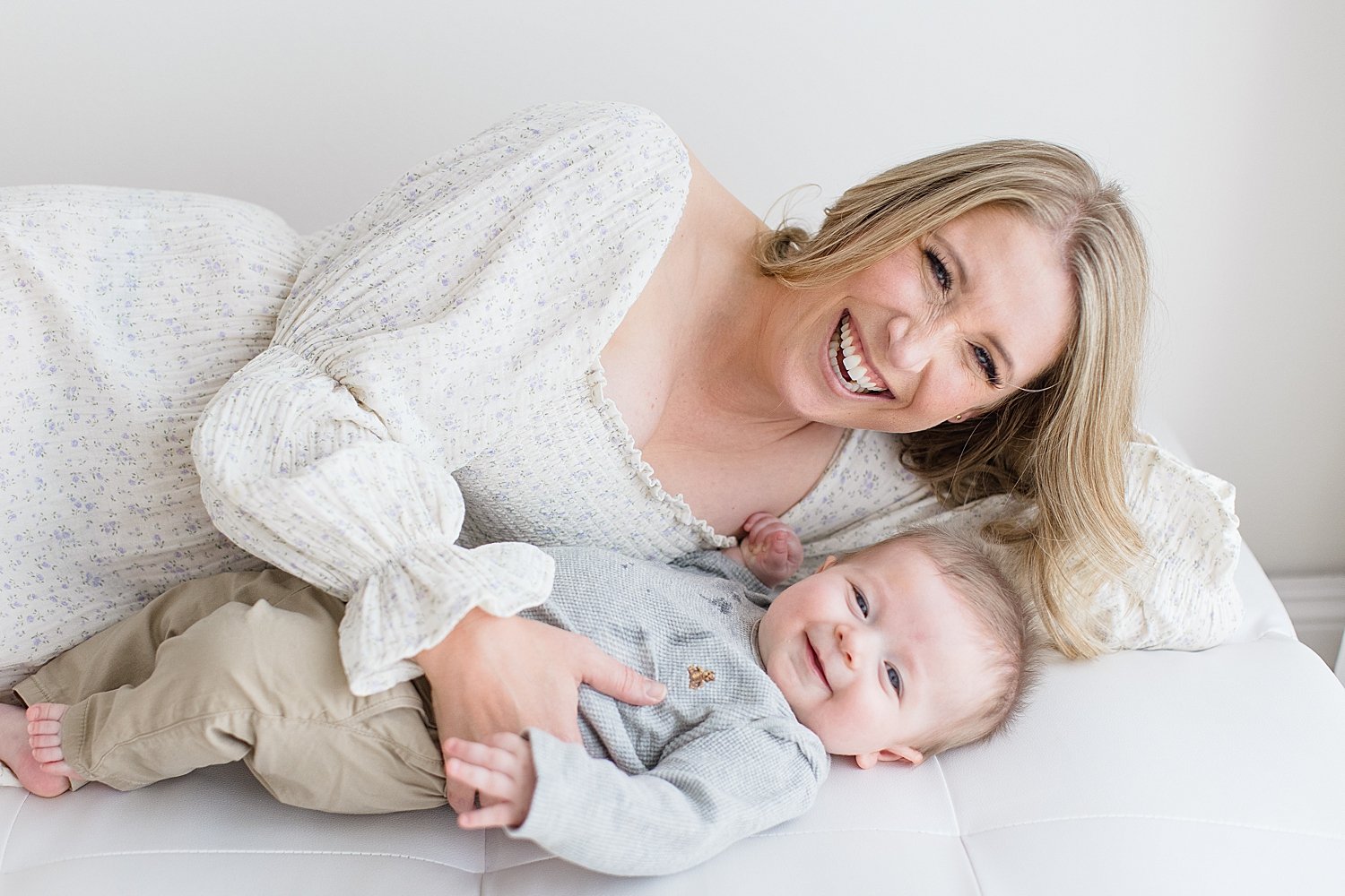 Mom and son laying together smiling | Ambre Williams Photography