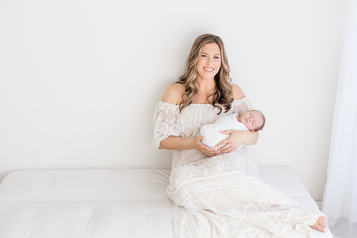 Mom holding her newborn son for photos in studio in Orange County, CA | Ambre Williams Photography