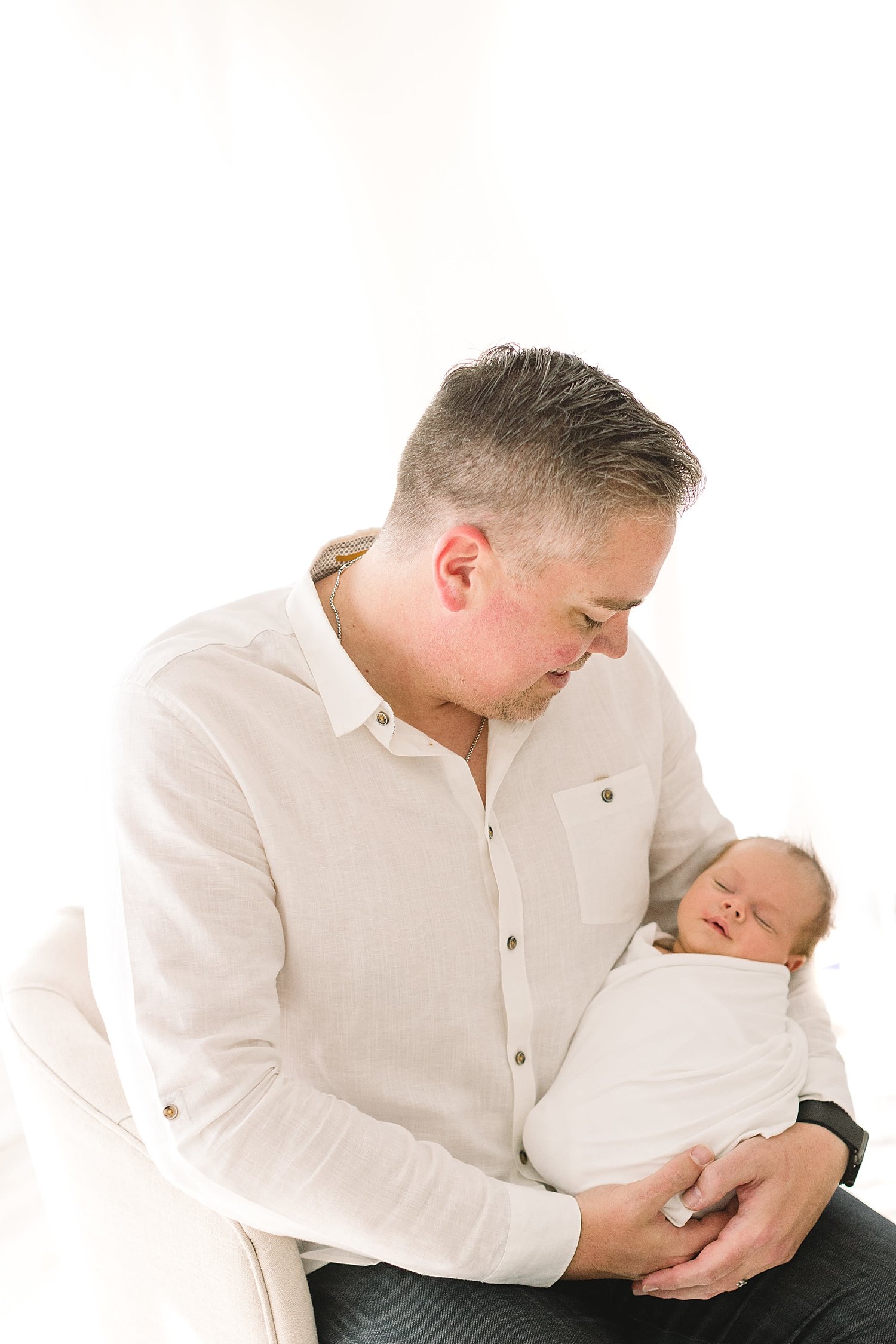 Father-son photos during newborn photoshoot with Ambre Williams Photography