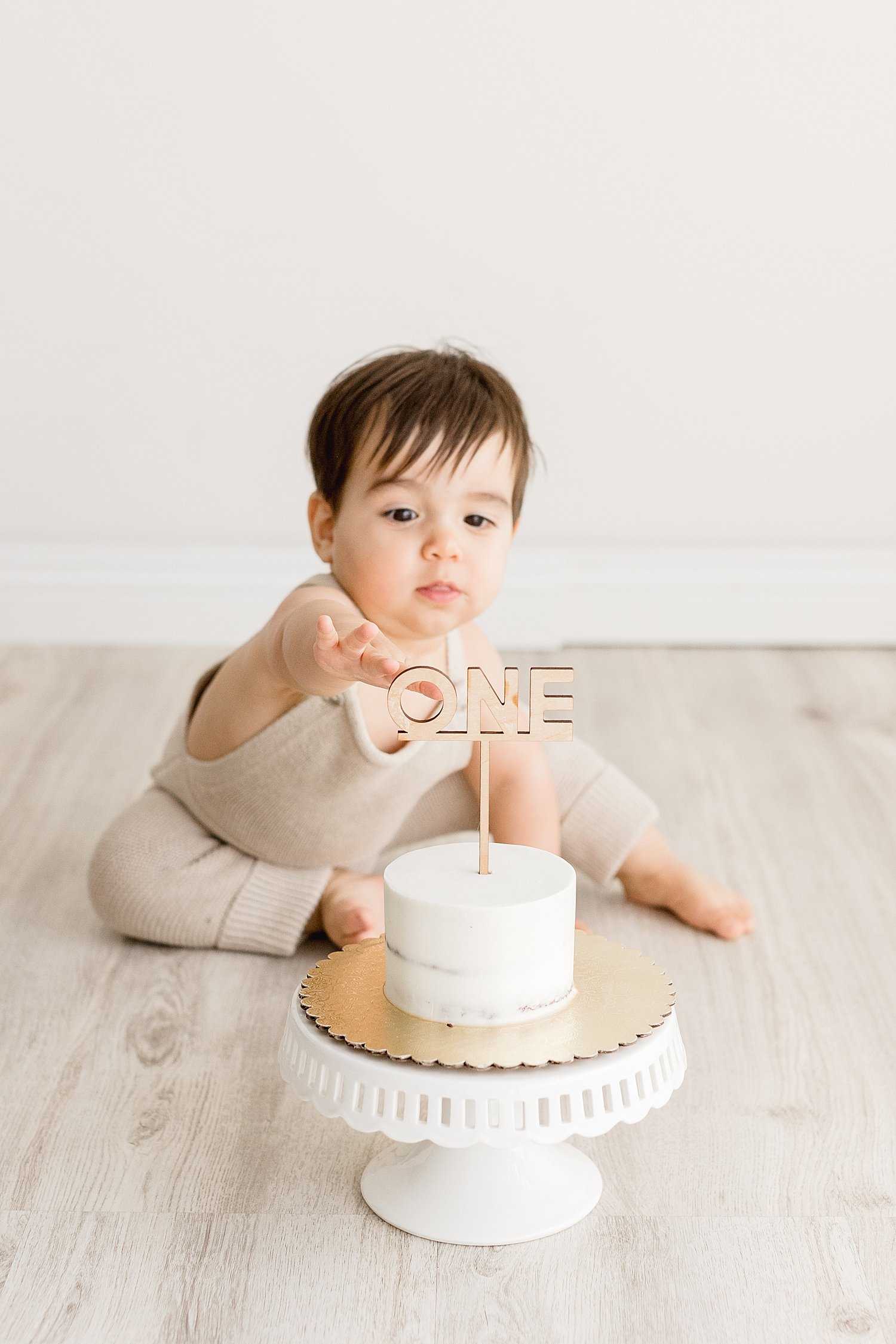 Cake smash session in Newport Beach studio for one year old with Ambre Williams Photography.