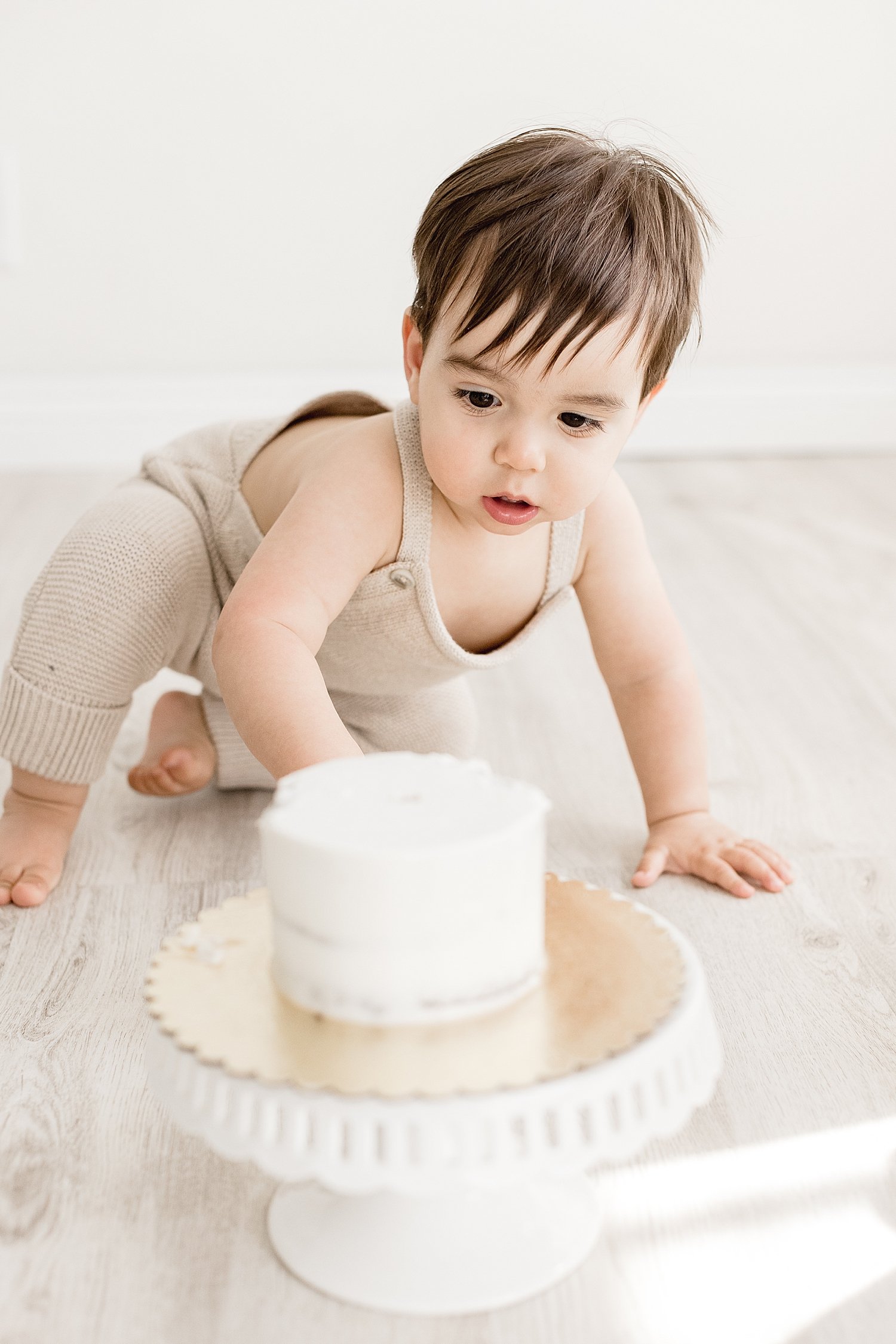 Cake smash session in Newport Beach studio for one year old with Ambre Williams Photography.