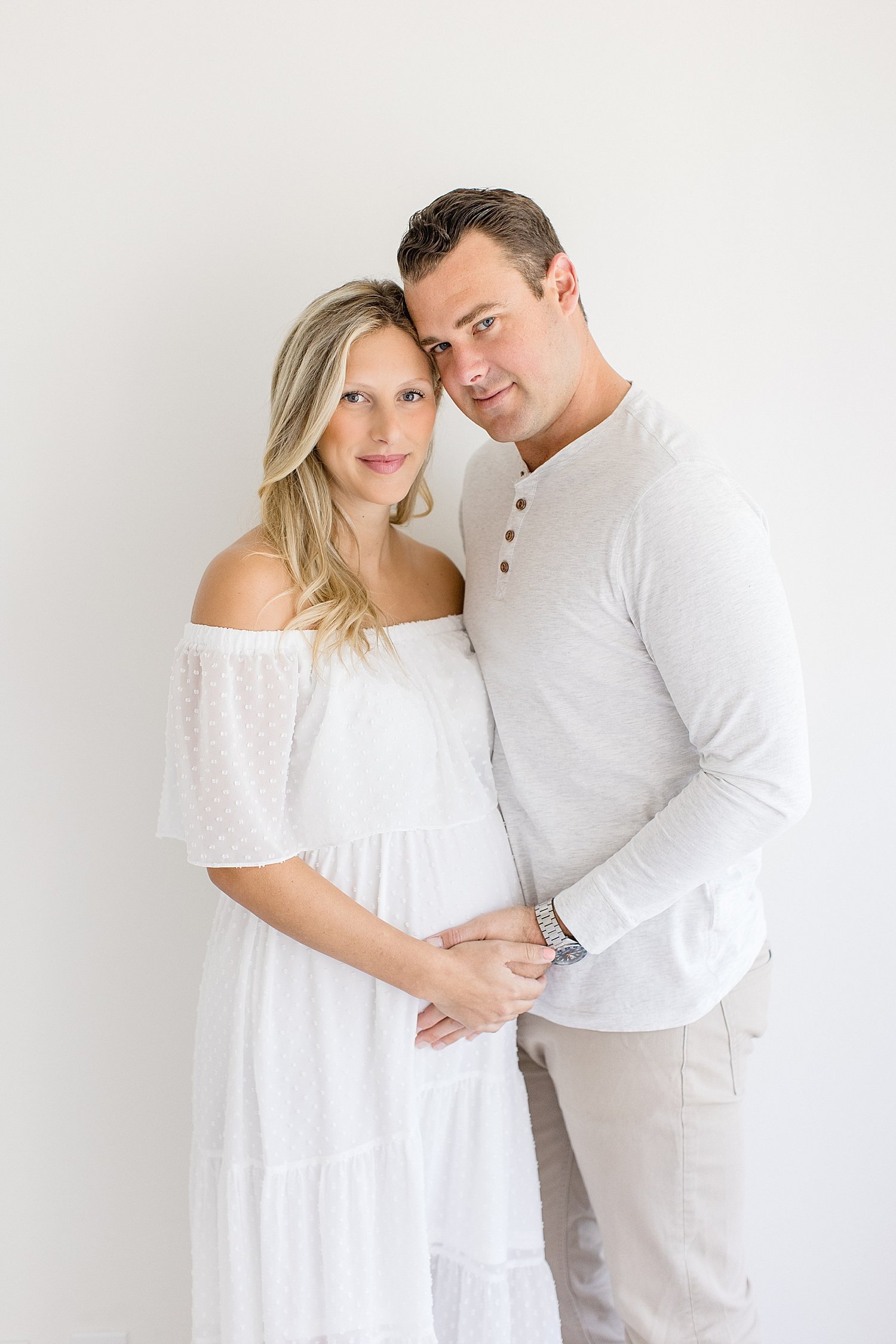 Expecting parents in studio for maternity photoshoot with Ambre Williams Photography.