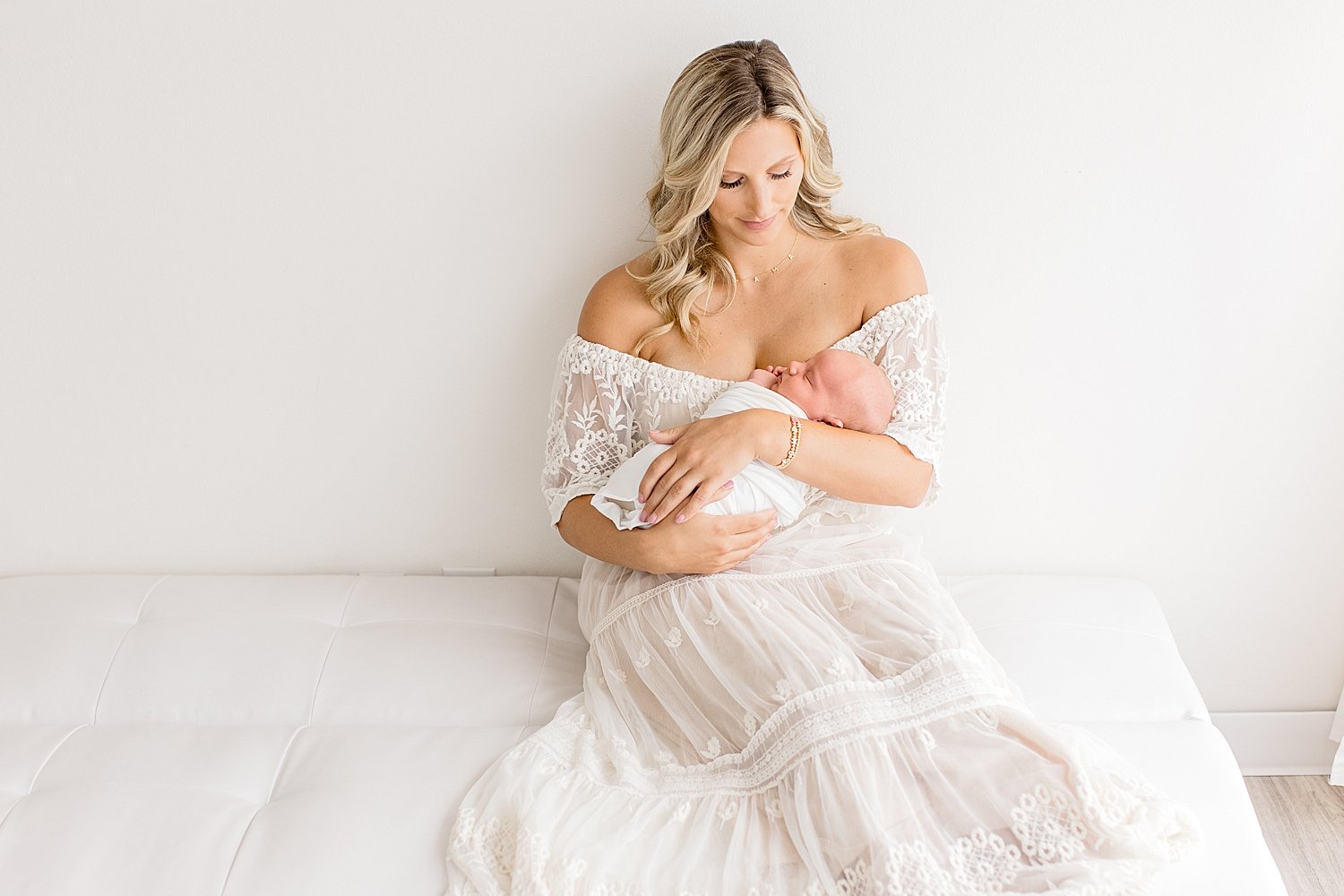Mom holding her newborn son for photos in studio Newport Beach | Ambre Williams Photography