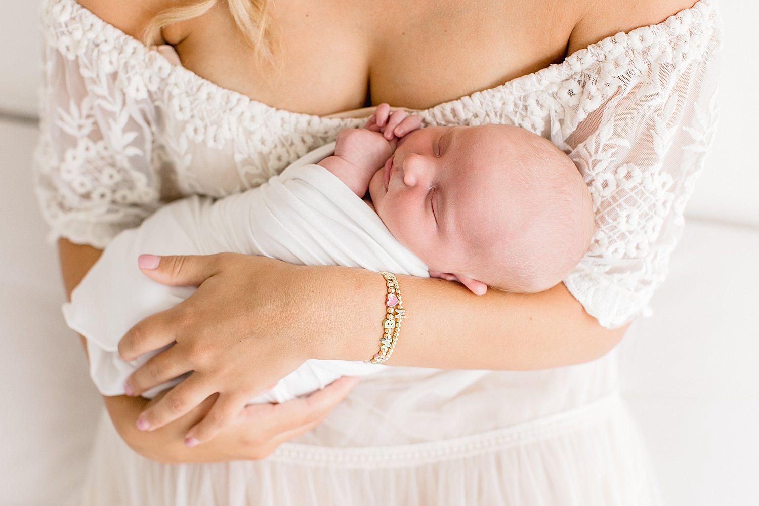 Mom holding her newborn son for photos in studio in Newport Beach | Ambre Williams Photography
