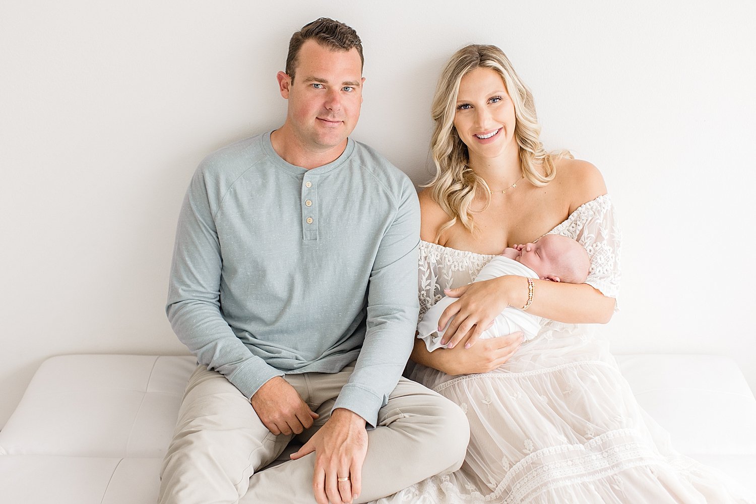 New parents holding their newborn son in Newport Beach studio with Ambre Williams Photography.