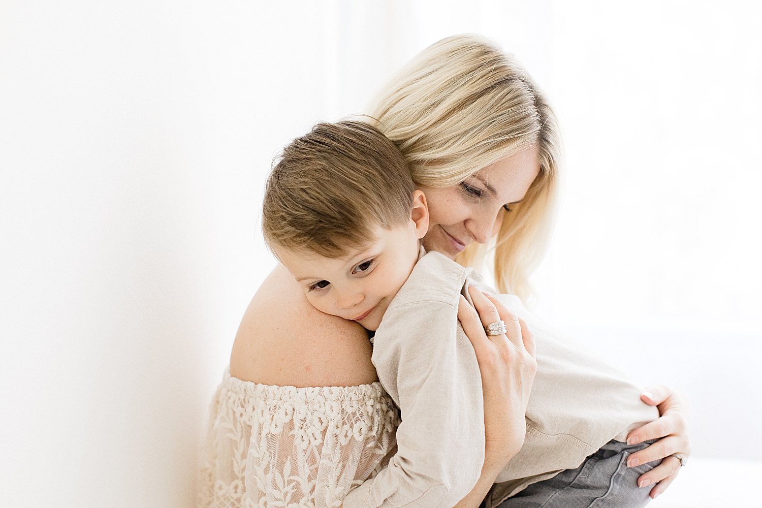 Mom embraces child with Ambre Williams Photography