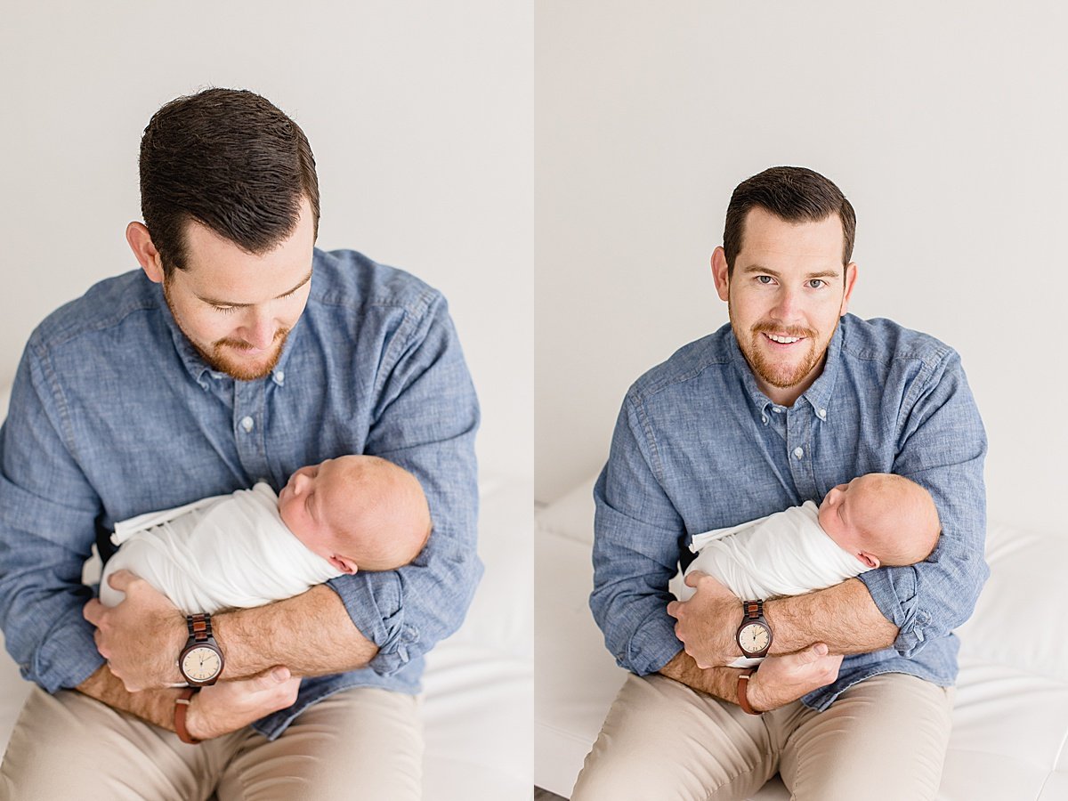 Dad holding newborn baby during portrait session with Ambre Williams Photography in Newport Beach