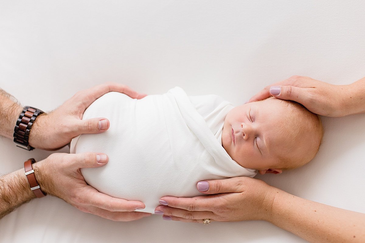 Mom and Dad holding newborn baby during Newborn Portrait Studio at Newport Beach Studio with Ambre Williams Photography