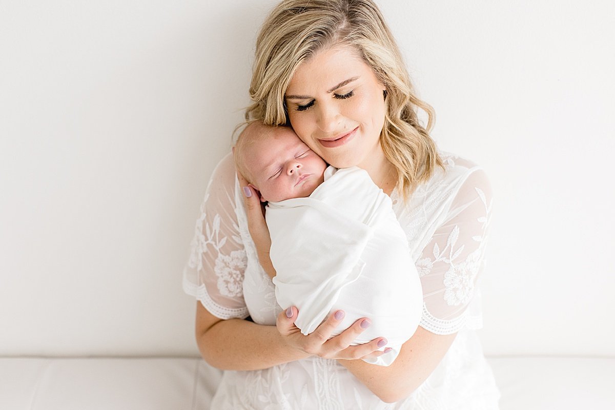 Beautiful Mama holding newborn baby during studio session in newport beach | Ambre Williams Photography