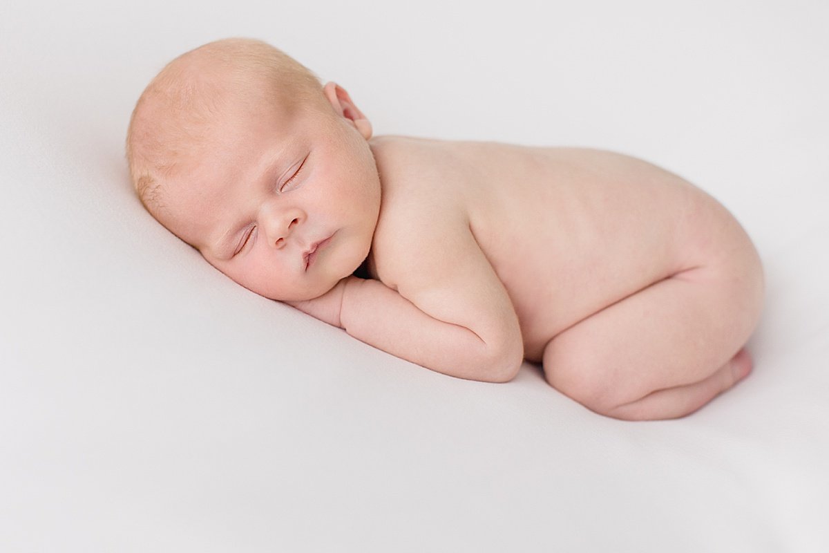 Sleeping Newborn during portrait session with Ambre Williams Photography  in Newport Beach