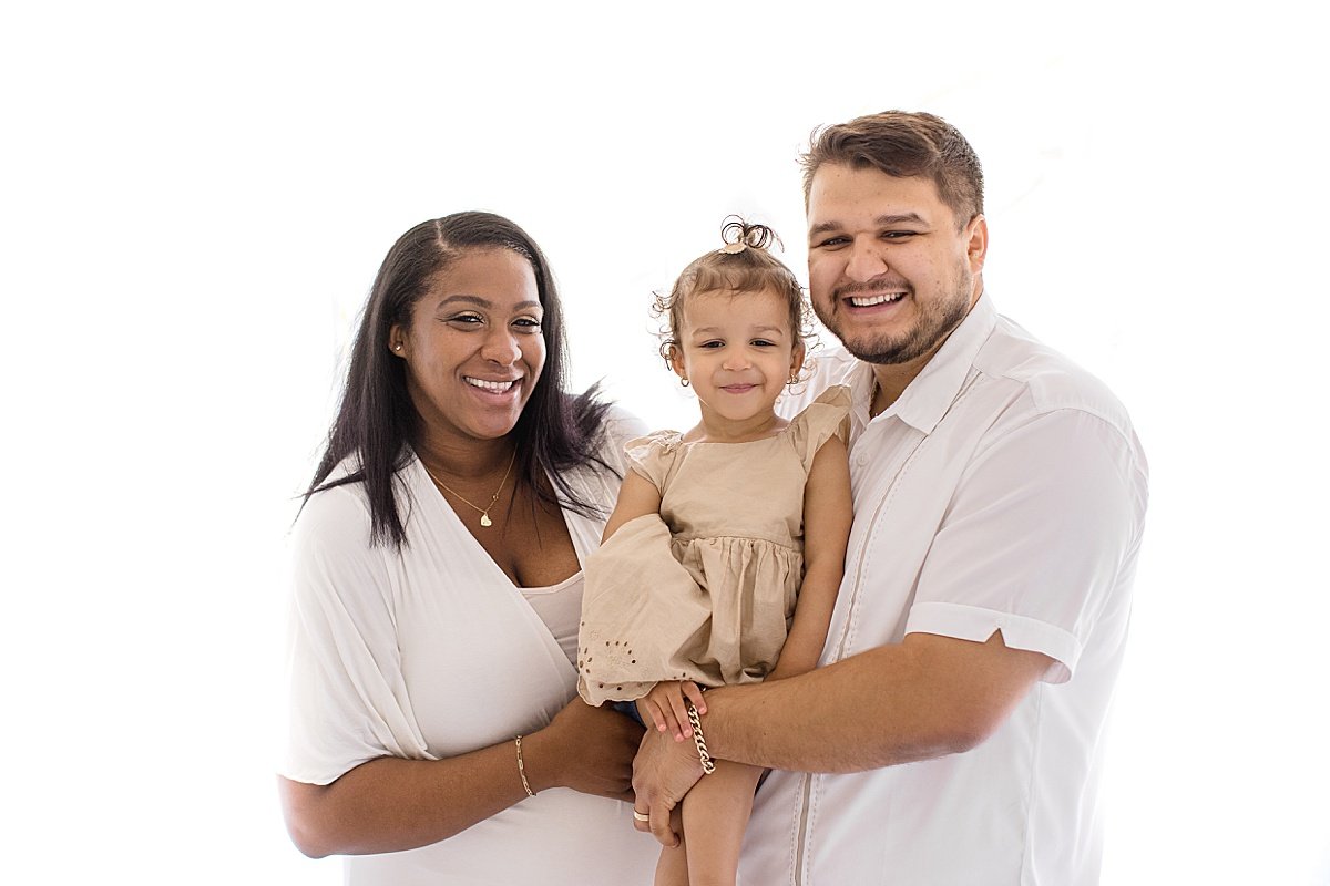 Family smiling together during maternity session in Ambre Williams studio at Newport Beach