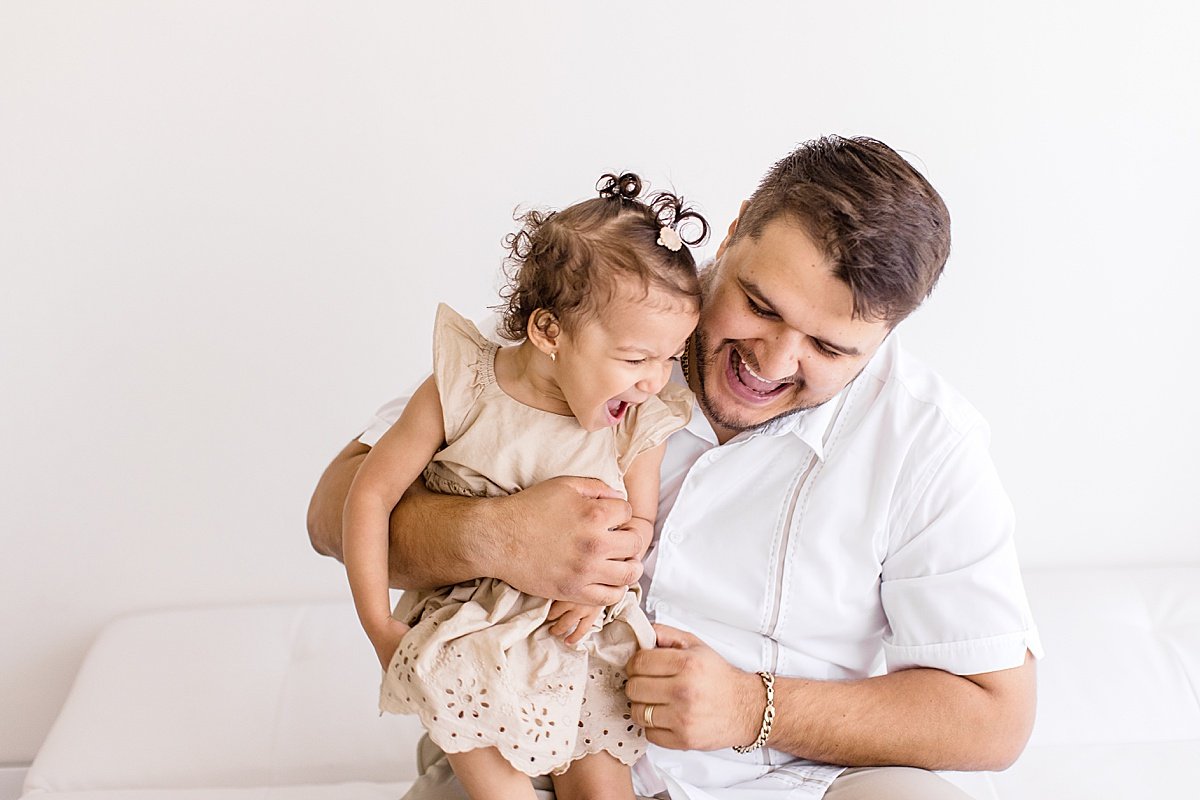 Candid Dad and daughter photo during Maternity Studio Session with Ambre WIlliams Photography in Newport Beach