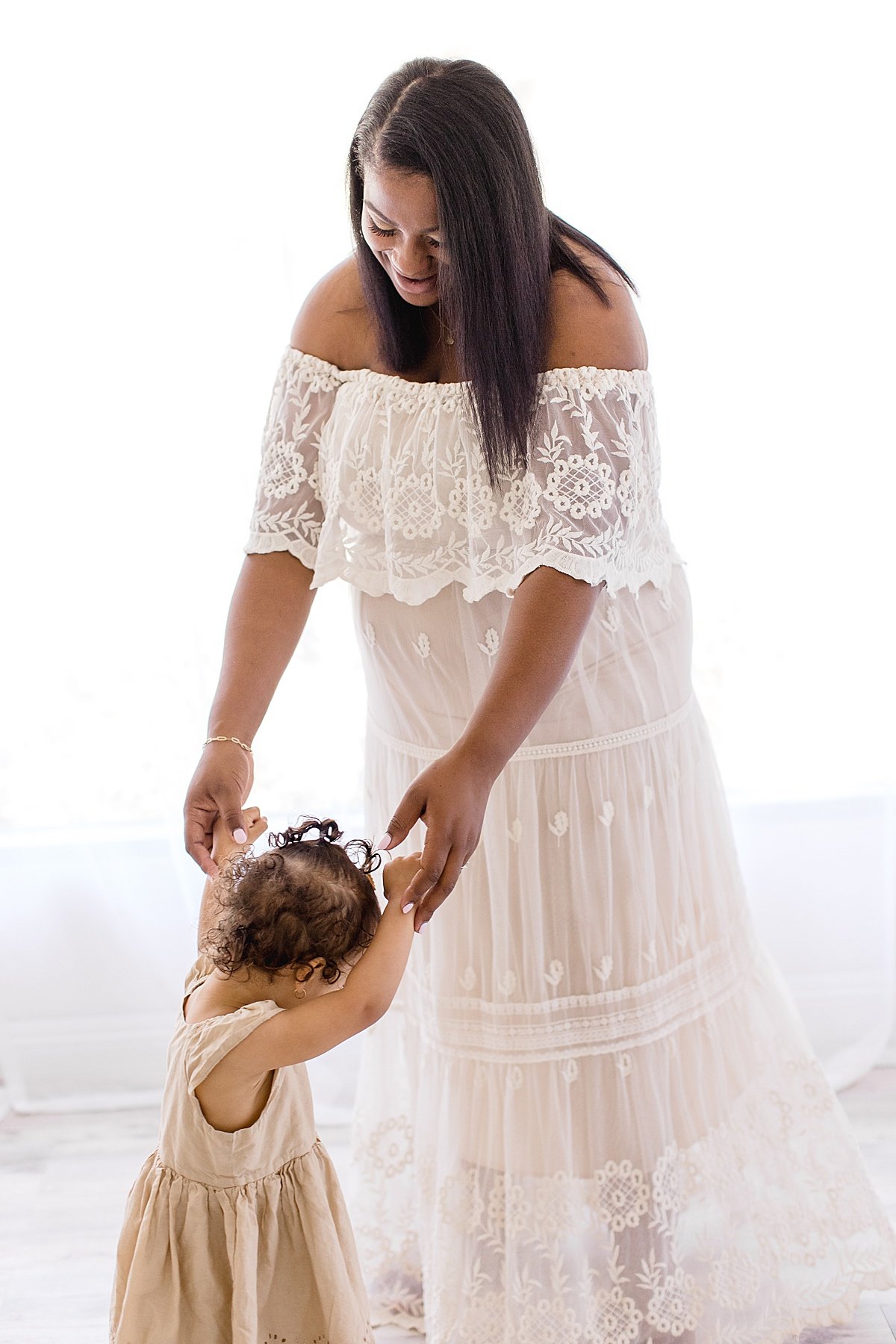 Mom and Daughter dancing together during Maternity Session with Ambre Williams Photography in Newport Beach
